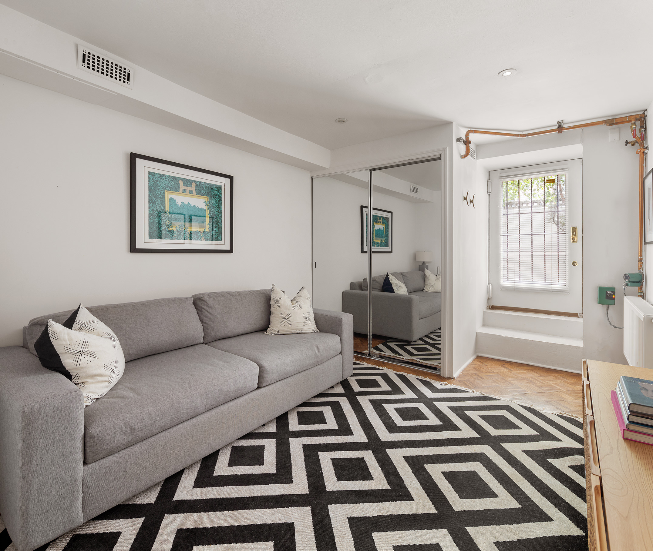71 East 3rd Street, Unit 4 Manhattan, NY 10003 - Photo 10 of 18 a living room with furniture and a rug