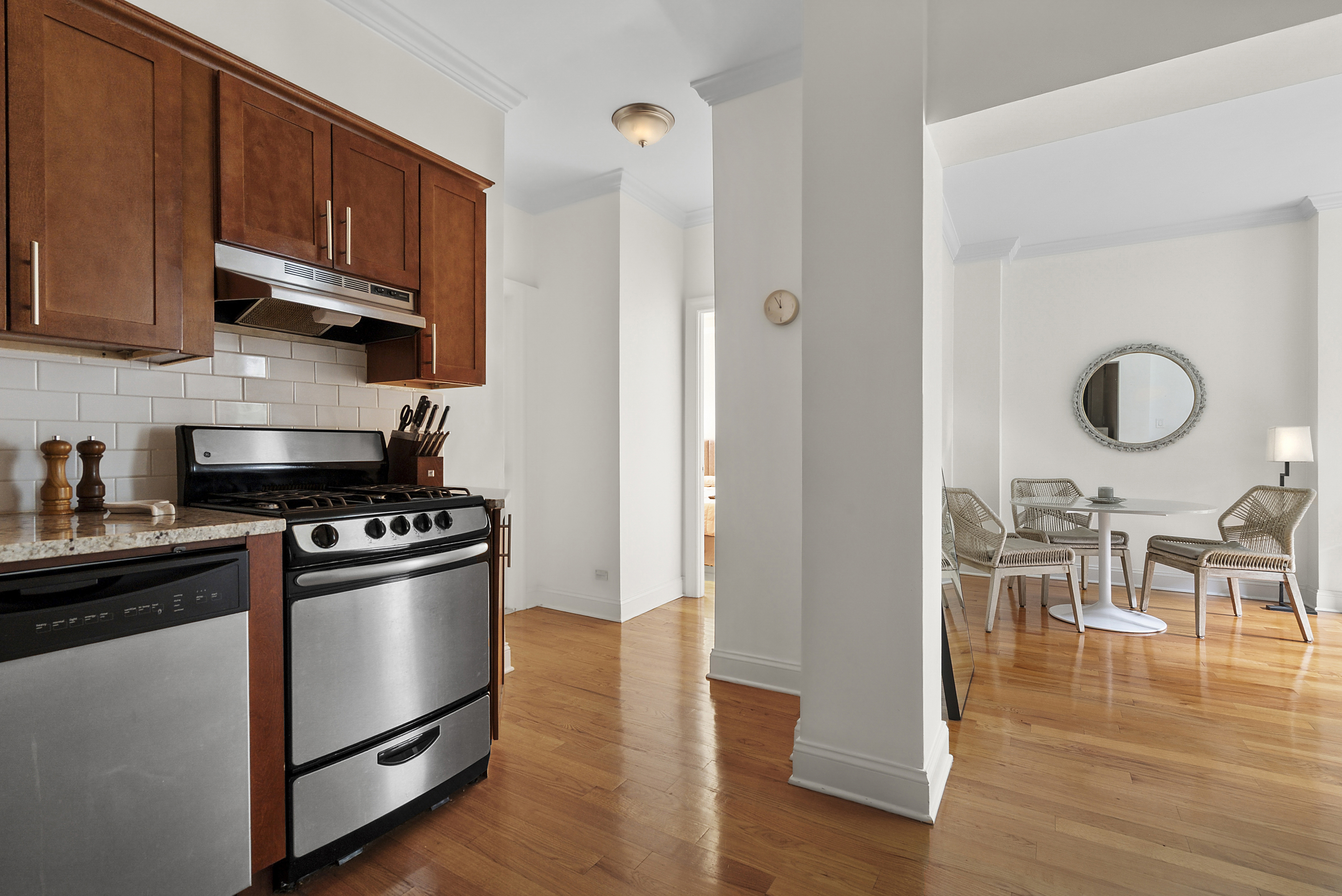 273 Bennett Avenue, Unit 3F Manhattan, NY 10040 - Photo 3 of 9 a kitchen with granite countertop wooden floors and stainless steel appliances