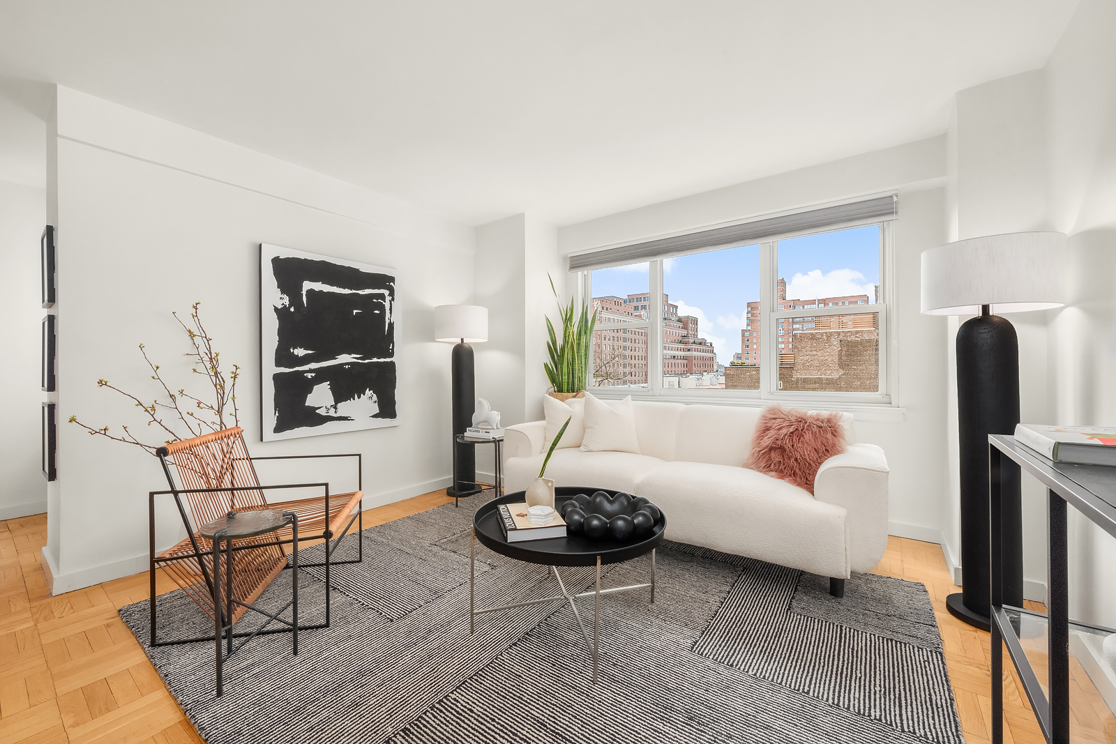 101 West 12th Street, Unit 10F Manhattan, NY 10011 - Photo 2 of 12 a living room with furniture and a flat screen tv