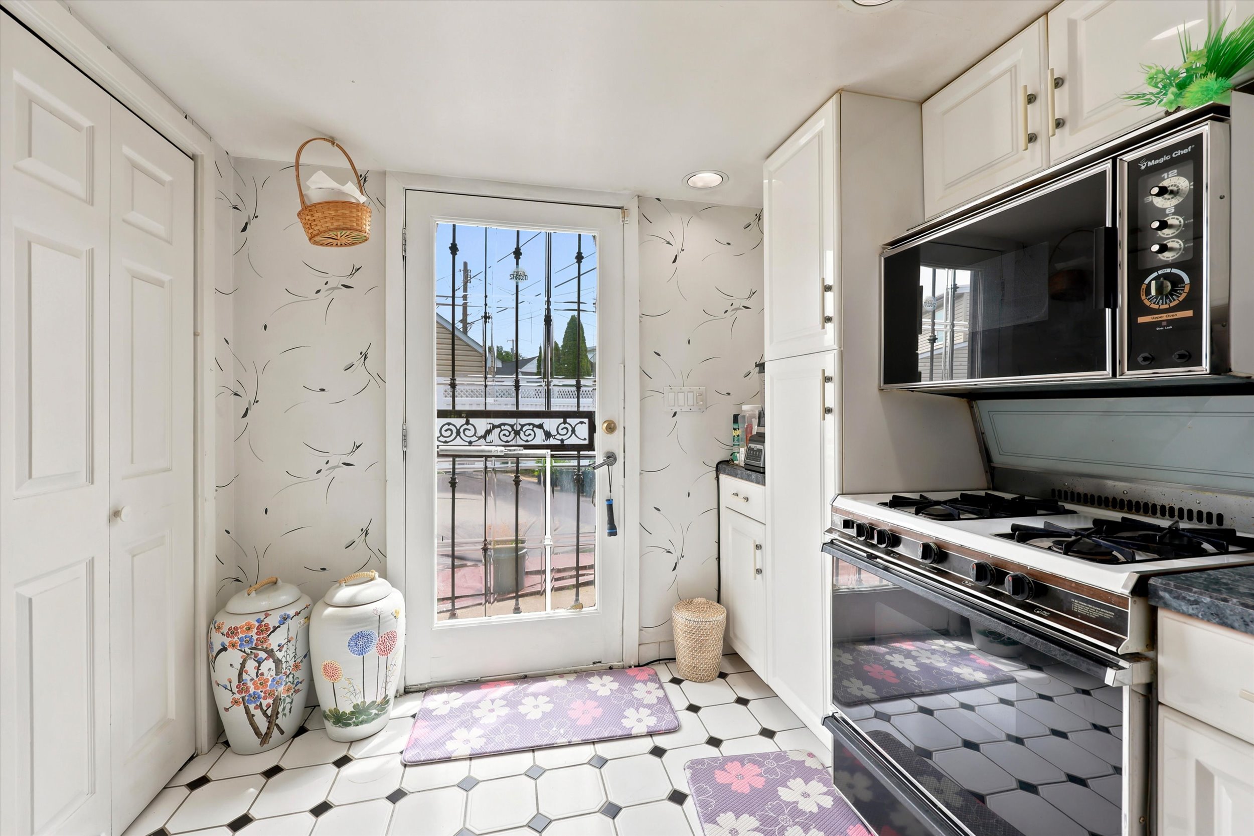897 Pine Hill Avenue Philadelphia, PA 19115 - Photo 16 of 22 a kitchen with granite countertop a stove a sink and a window