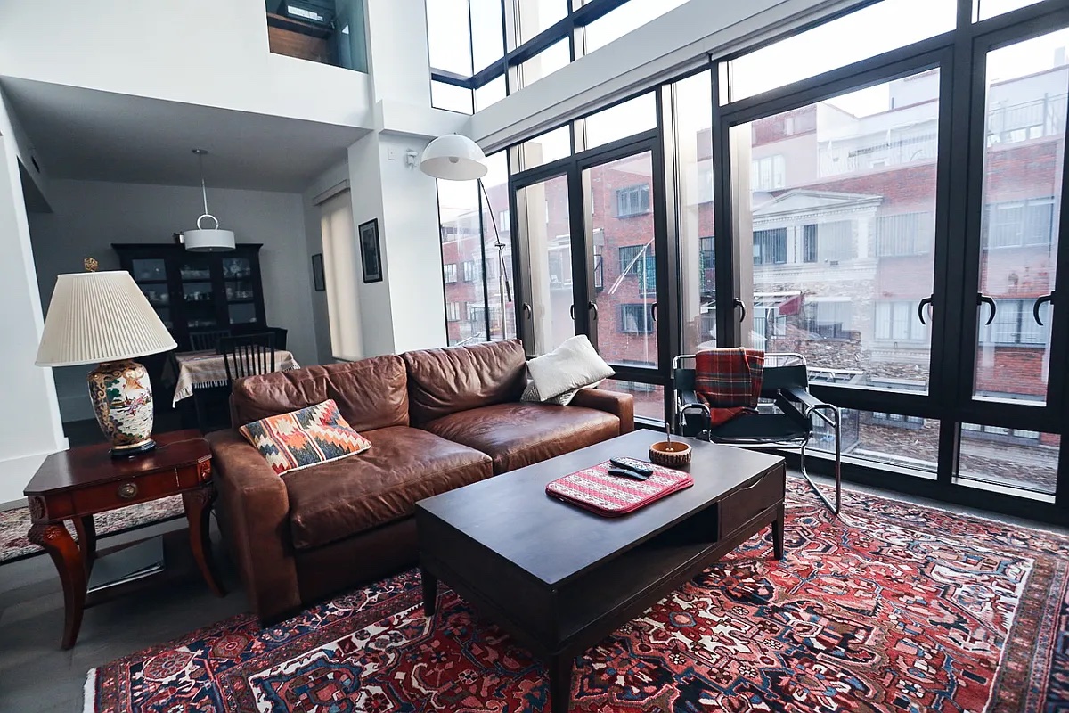 429 Kent Avenue, Unit D722 Brooklyn, NY 11249 - Photo 1 of 18 a living room with furniture and a rug