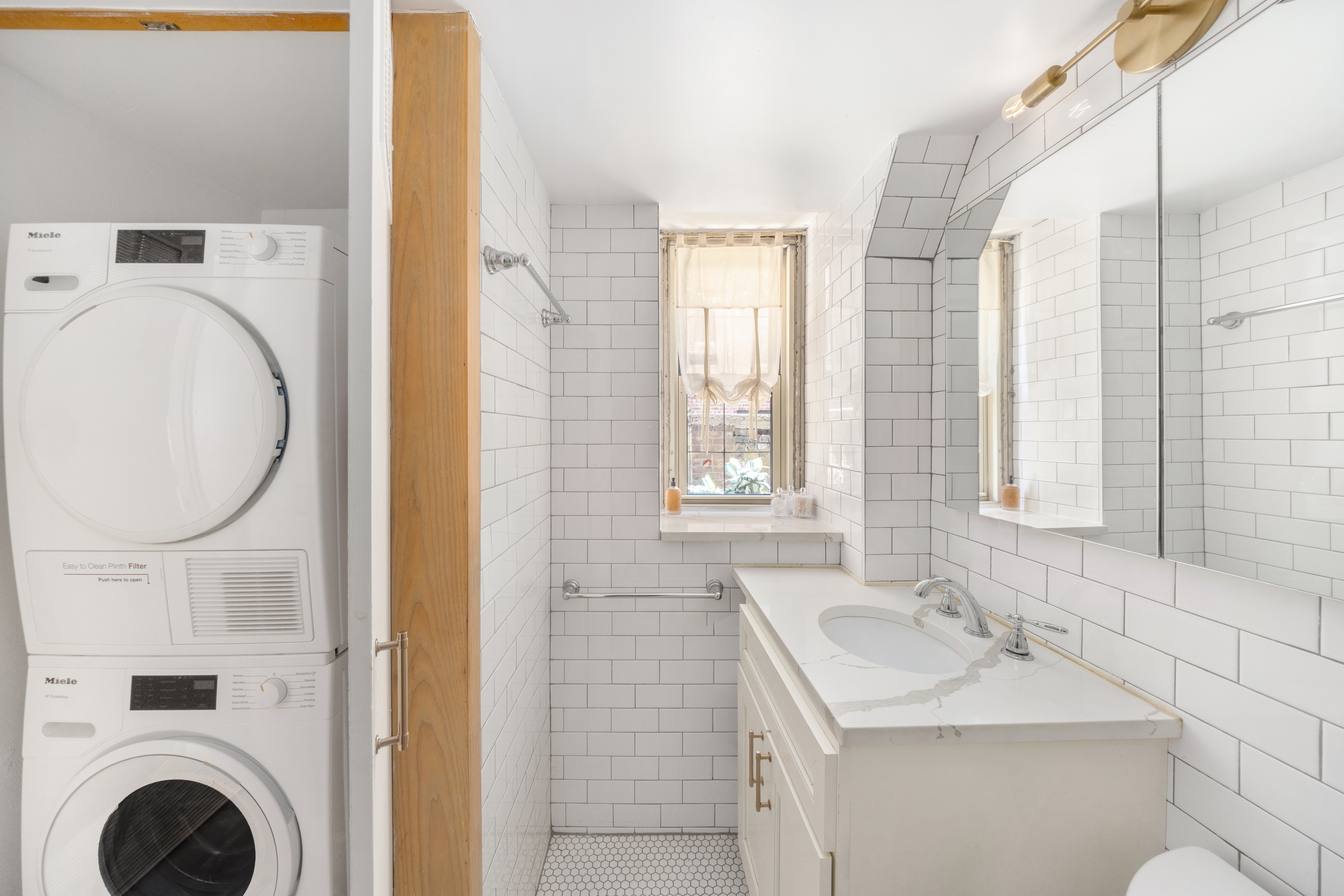 71 Barrow Street, Unit 19 Manhattan, NY 10014 - Photo 6 of 9 a bathroom with a sink and a mirror