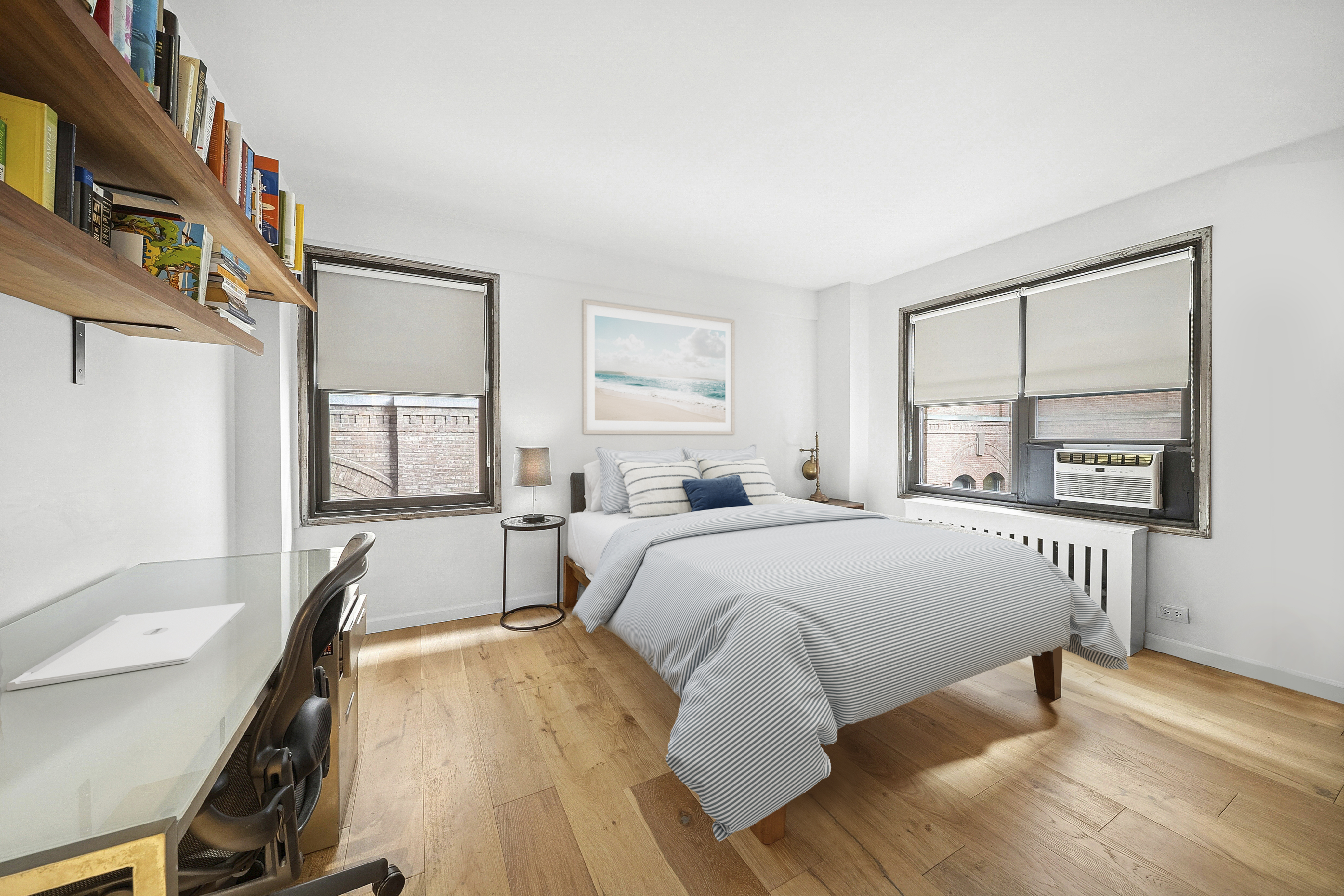 54 West 16th Street, Unit 2G Manhattan, NY 10011 - Photo 3 of 7 a bed sitting in a bedroom next to a window