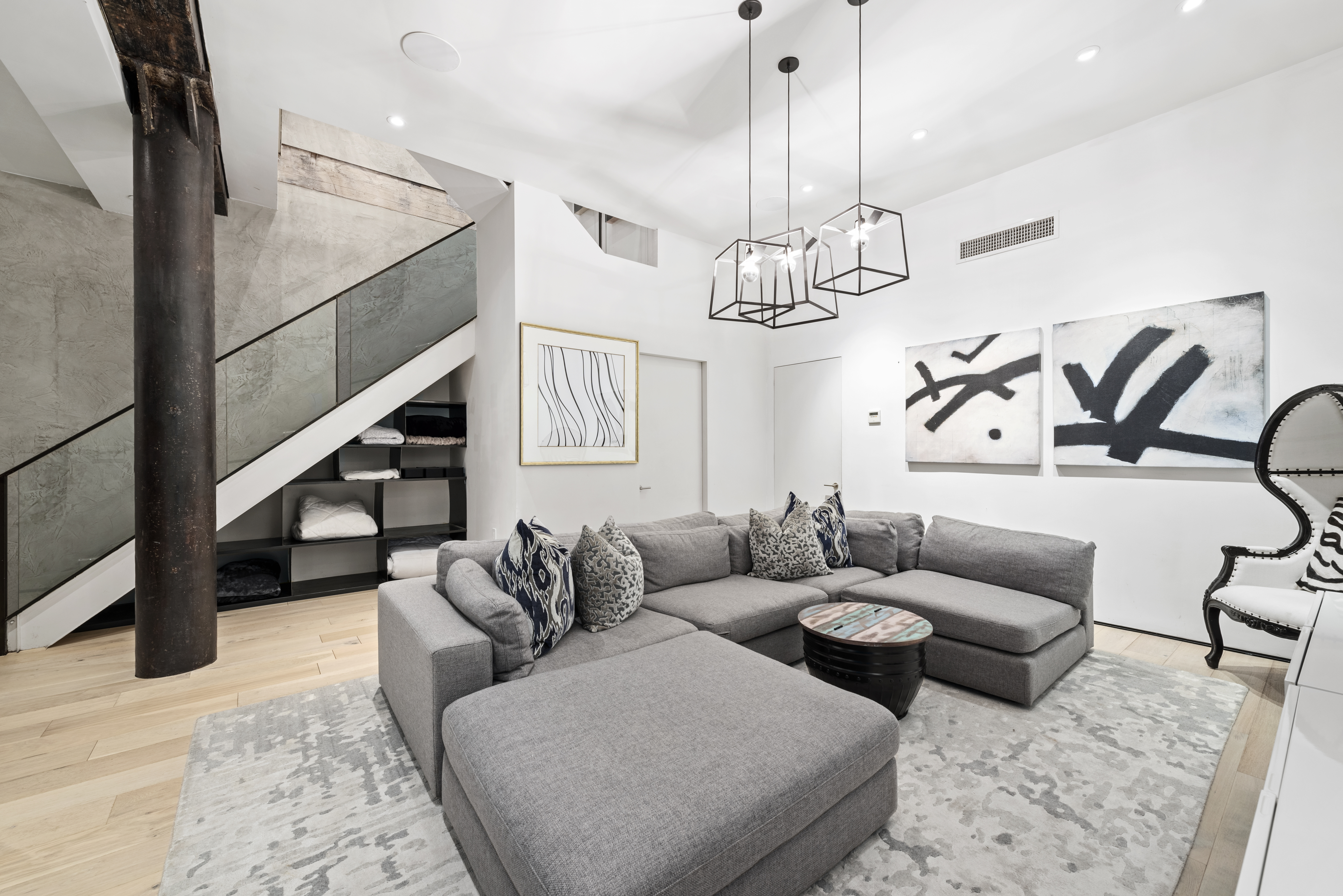 10 Bleecker Street, Unit 1B Manhattan, NY 10012 - Photo 8 of 16 a living room with furniture ceiling fan and wooden floor