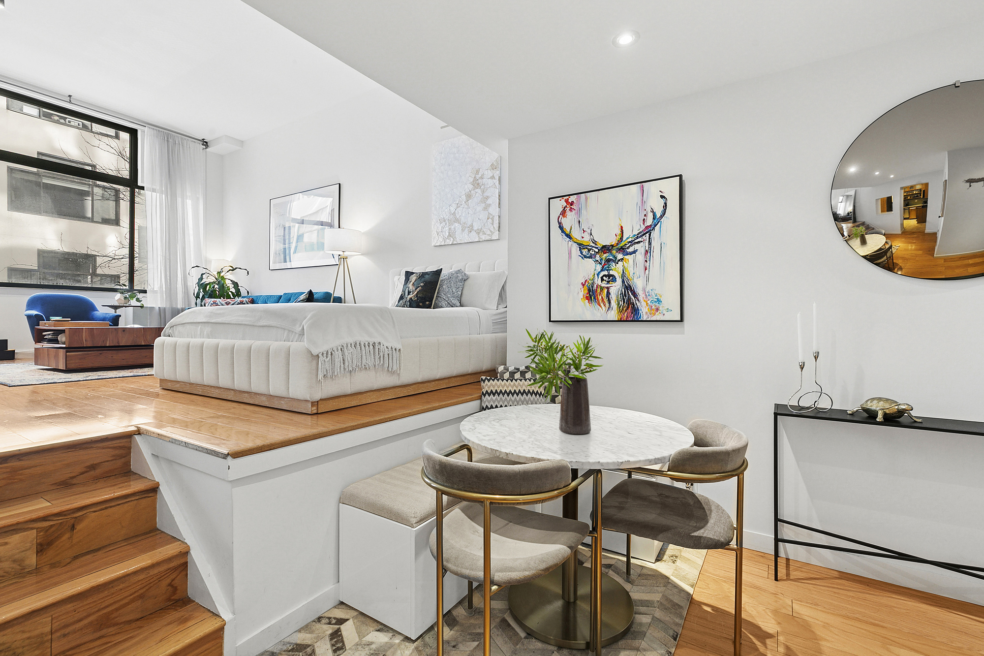 77 Bleecker Street, Unit 214 Manhattan, NY 10012 - Photo 2 of 5 a living room with dining table and wooden floor