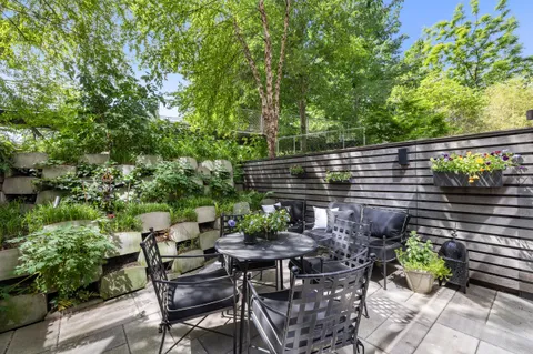 a backyard of a house with table and chairs
