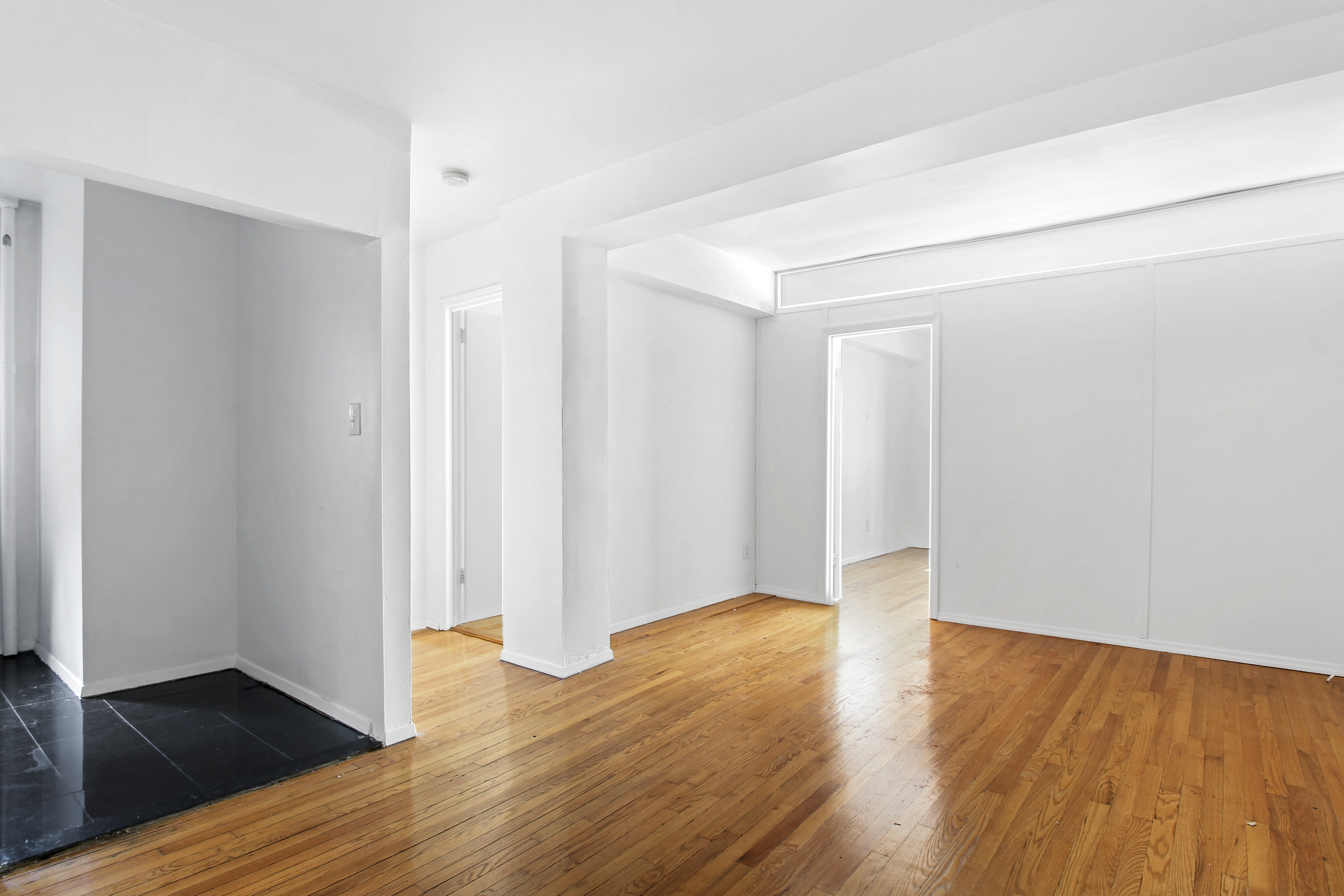 an empty room with wooden floor