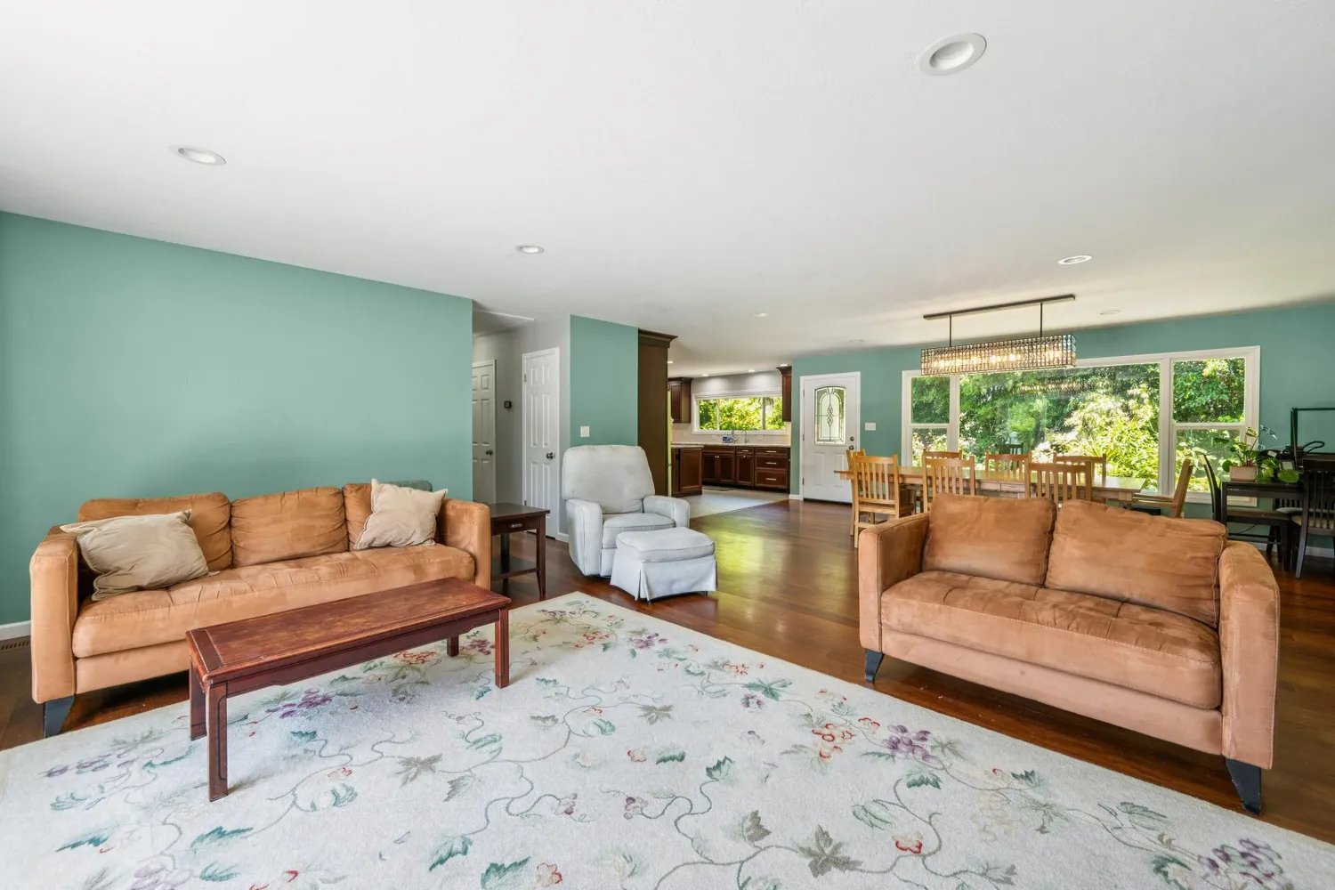 a kitchen with stainless steel appliances granite countertop a stove a refrigerator and a dining table