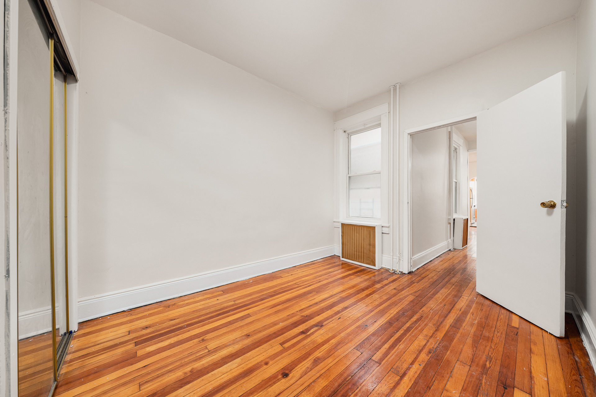 70-03 66th Street, Unit 1L Queens, NY 11385 - Photo 5 of 8 a view of a livingroom with wooden floor