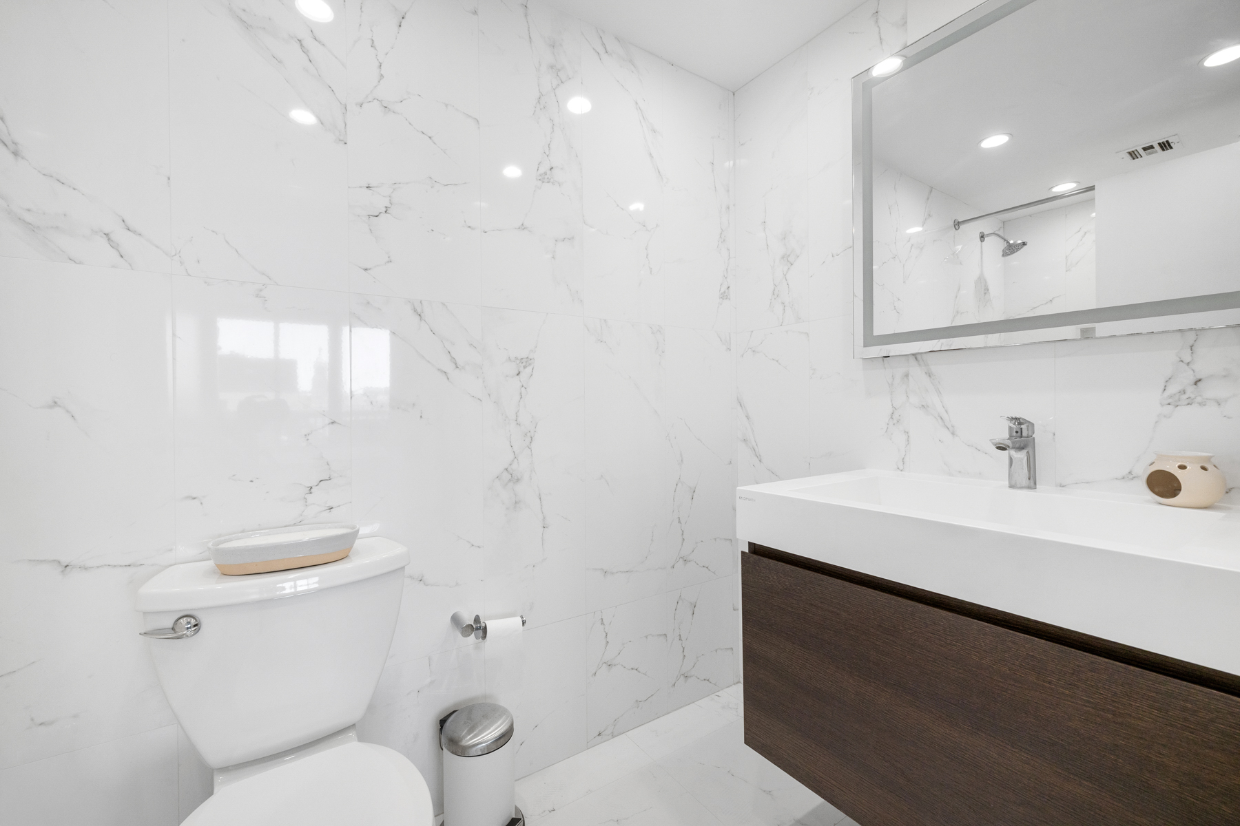 50 Lexington Avenue, Unit 25E Manhattan, NY 10010 - Photo 10 of 13 a bathroom with a sink a toilet and shower