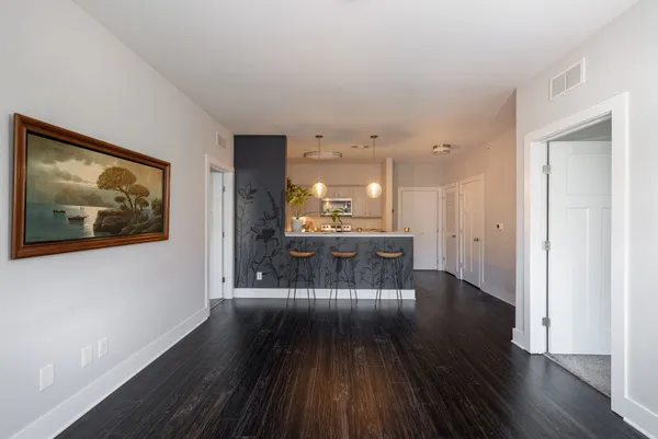 a view of a living room with wooden floor