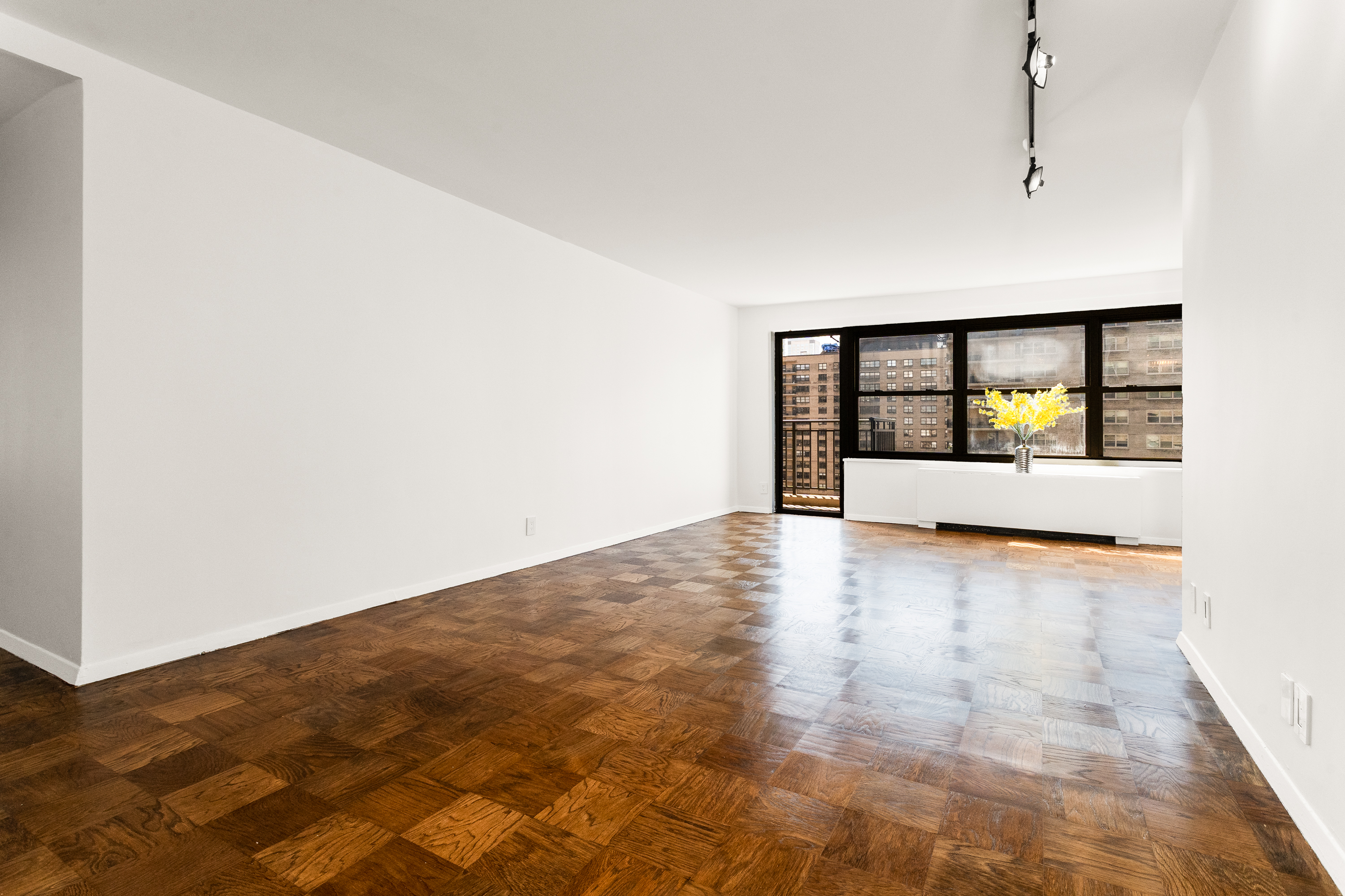 180 West End Avenue, Unit 23D Manhattan, NY 10023 - Photo 4 of 22 a view of empty room with wooden floor and window