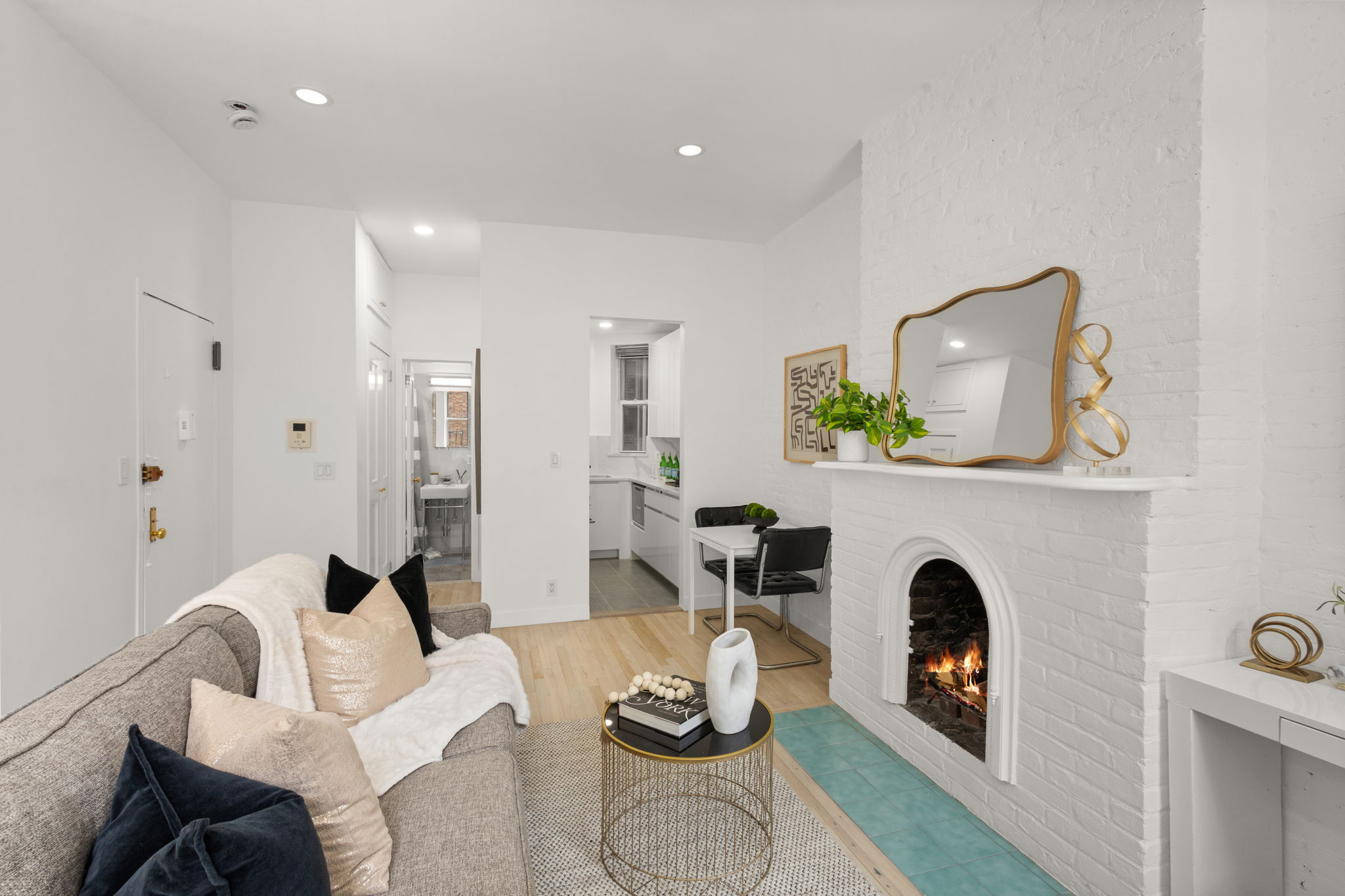 237 East 12th Street, Unit 2A Manhattan, NY 10003 - Photo 4 of 16 a living room with furniture and a fireplace