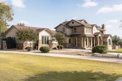 a living room with furniture a fireplace and a floor to ceiling window