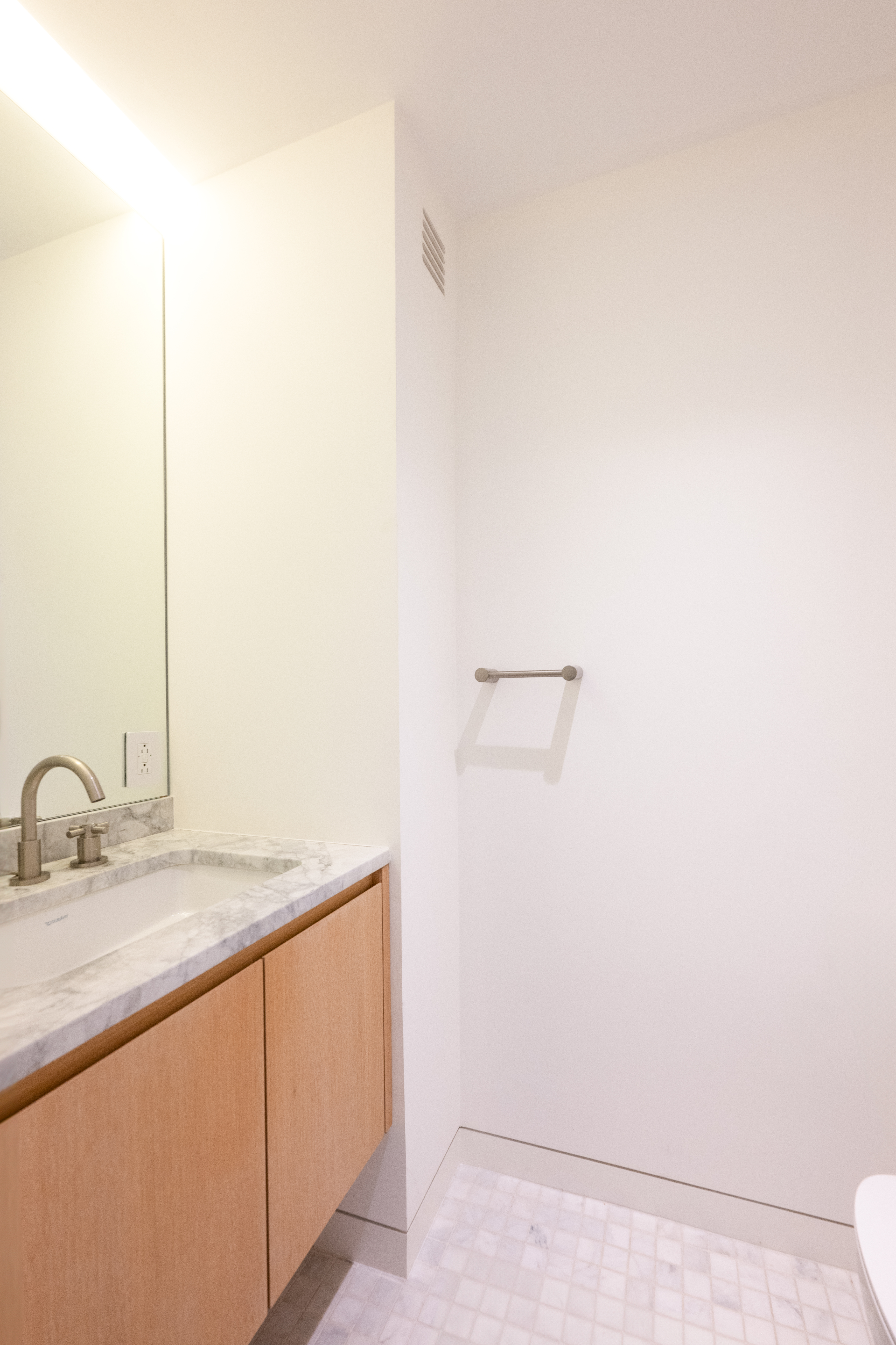 124 East 79th Street, Unit 7D Manhattan, NY 10075 - Photo 8 of 26 a bathroom with a sink and a mirror