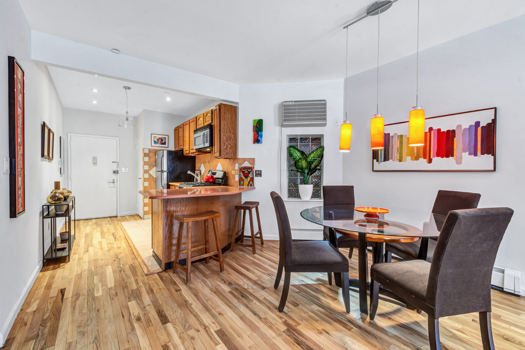 2322 Adam Clayton Powell Jr Boulevard, Unit 2G Manhattan, NY 10030 - Photo 2 of 8 a living room with furniture and a kitchen view
