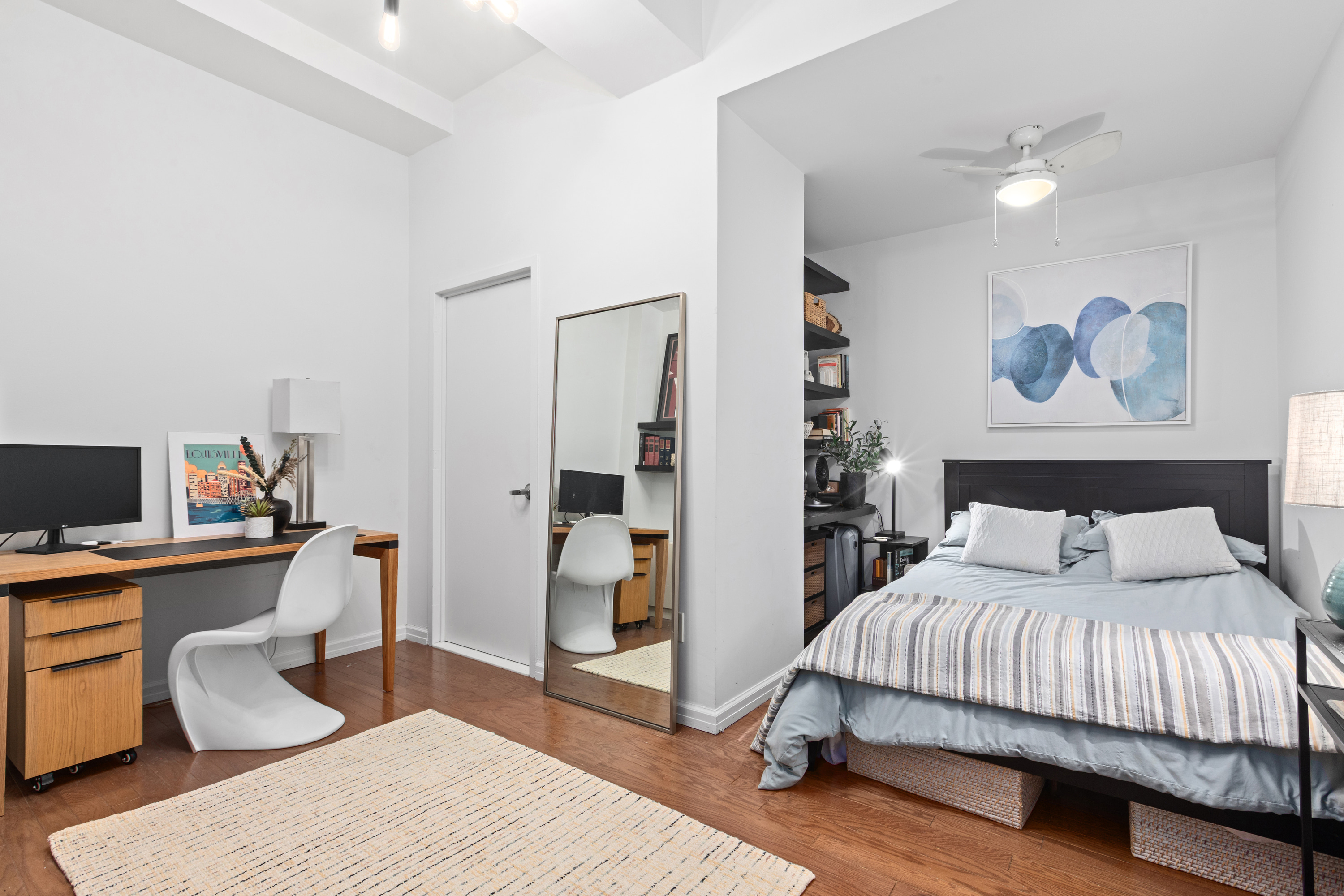 99 John Street, Unit 813 Manhattan, NY 10038 - Photo 5 of 20 a bedroom with a bed and a desk