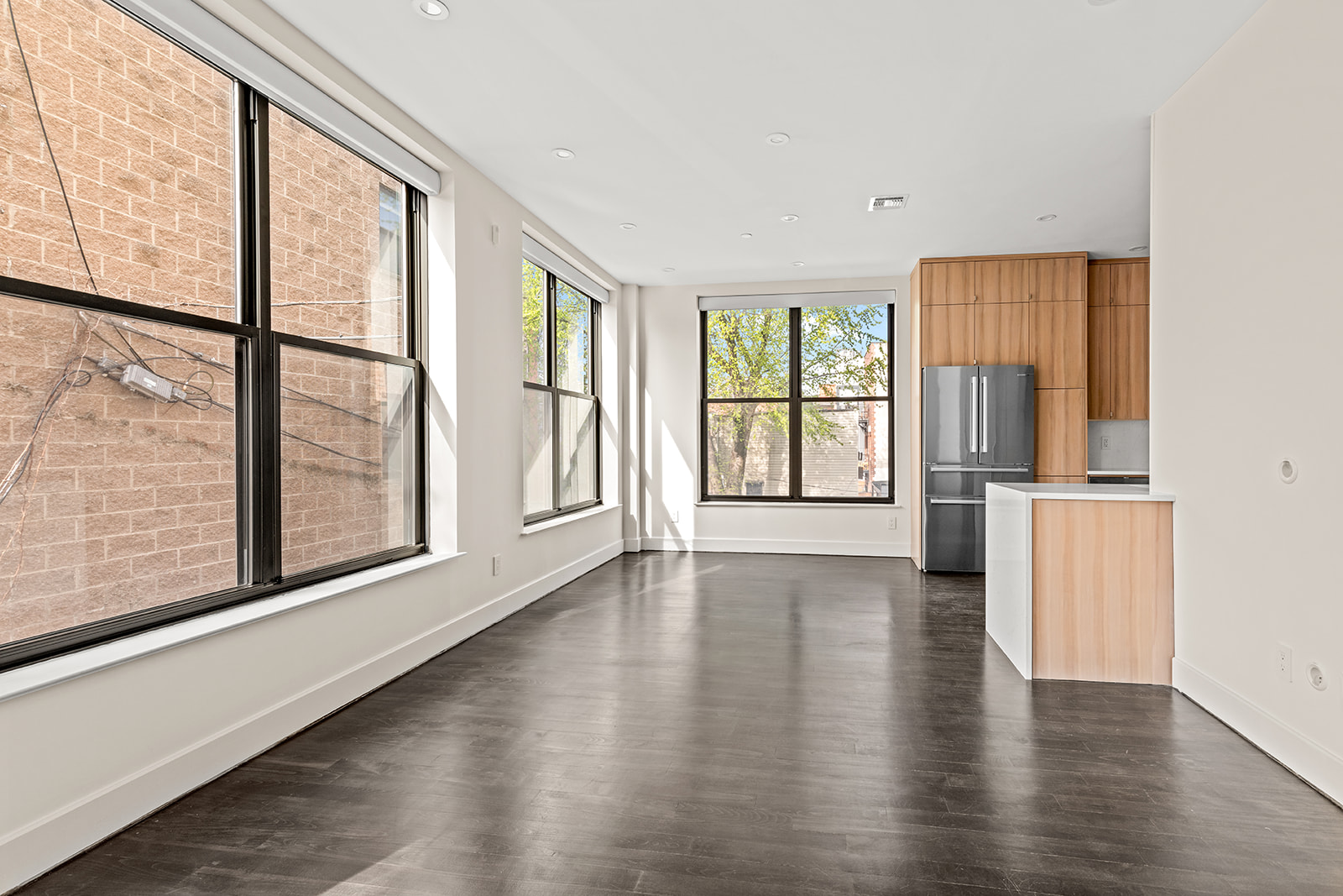 246 Withers Street, Unit 2G Brooklyn, NY 11211 - Photo 2 of 9 a view of an empty room with wooden floor and a window