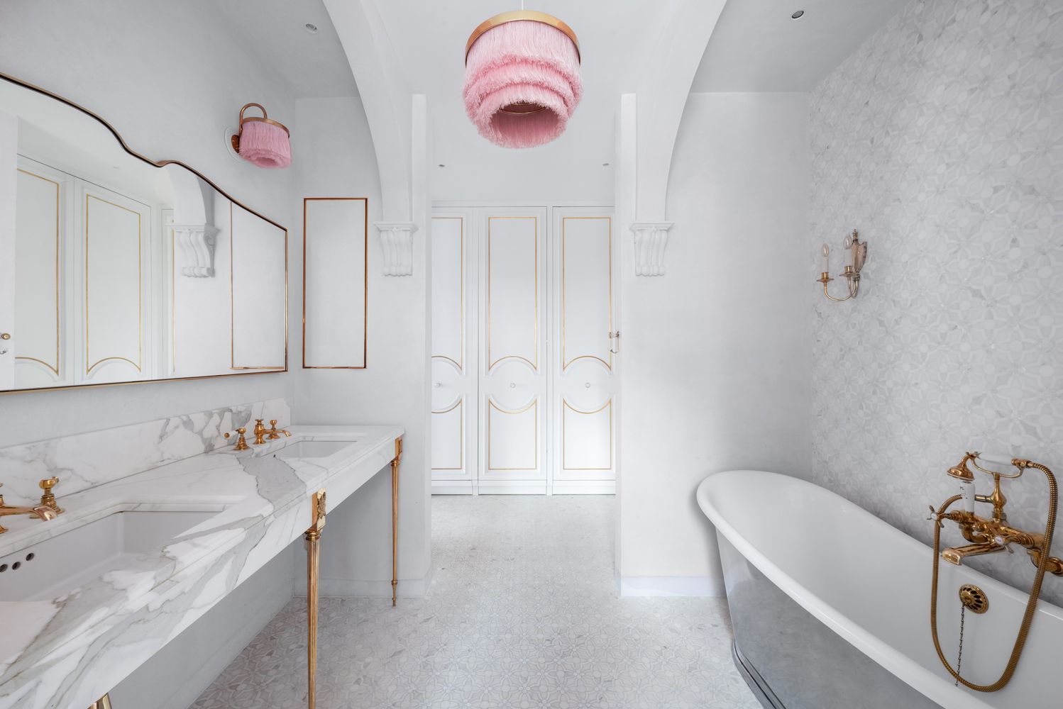 a bathroom with a tub sink and mirror