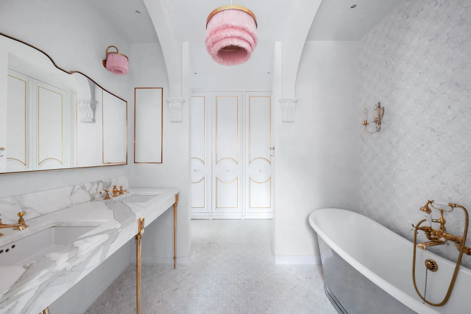 a bathroom with a tub sink and mirror