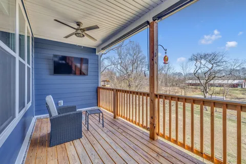 a view of a balcony with furniture and wooden floor