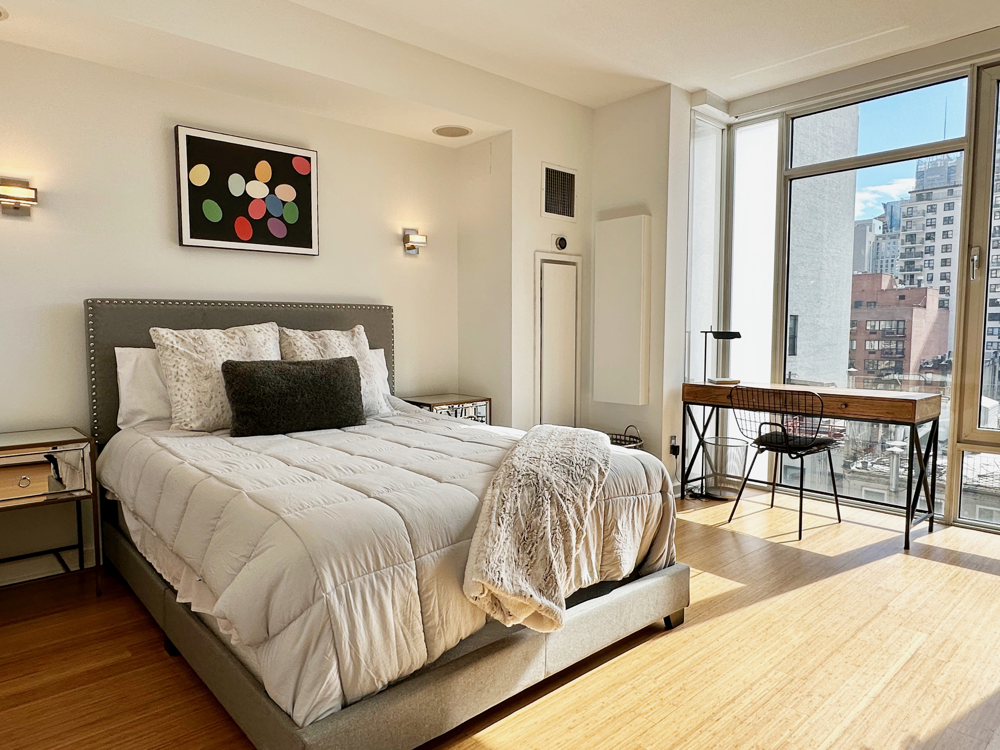 350 West 53rd Street, Unit PHA Manhattan, NY 10019 - Photo 10 of 35 a spacious bedroom with a bed and a table