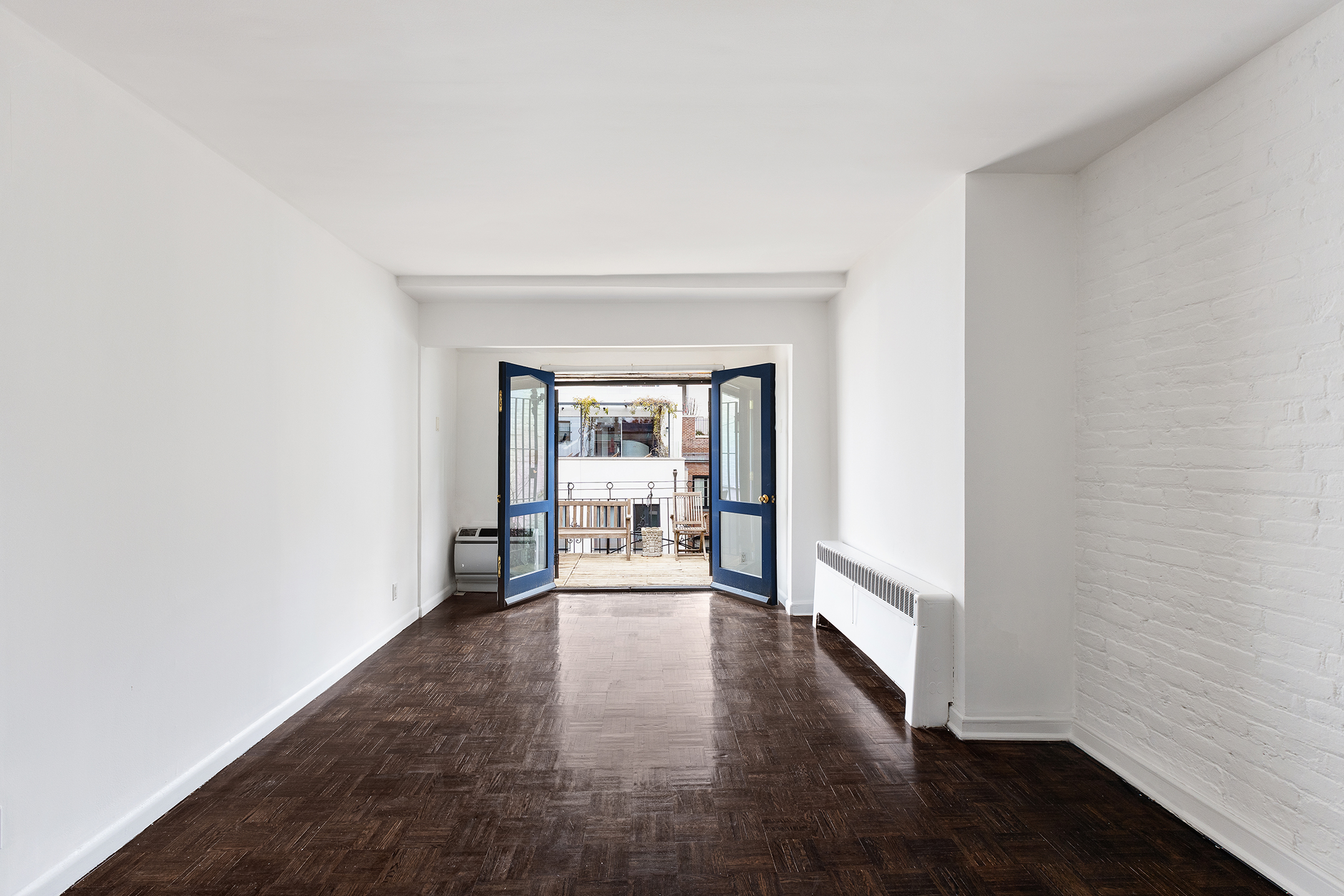 7 East 74th Street, Unit PH Manhattan, NY 10021 - Photo 6 of 10 a view of a hallway with wooden floor and a fireplace