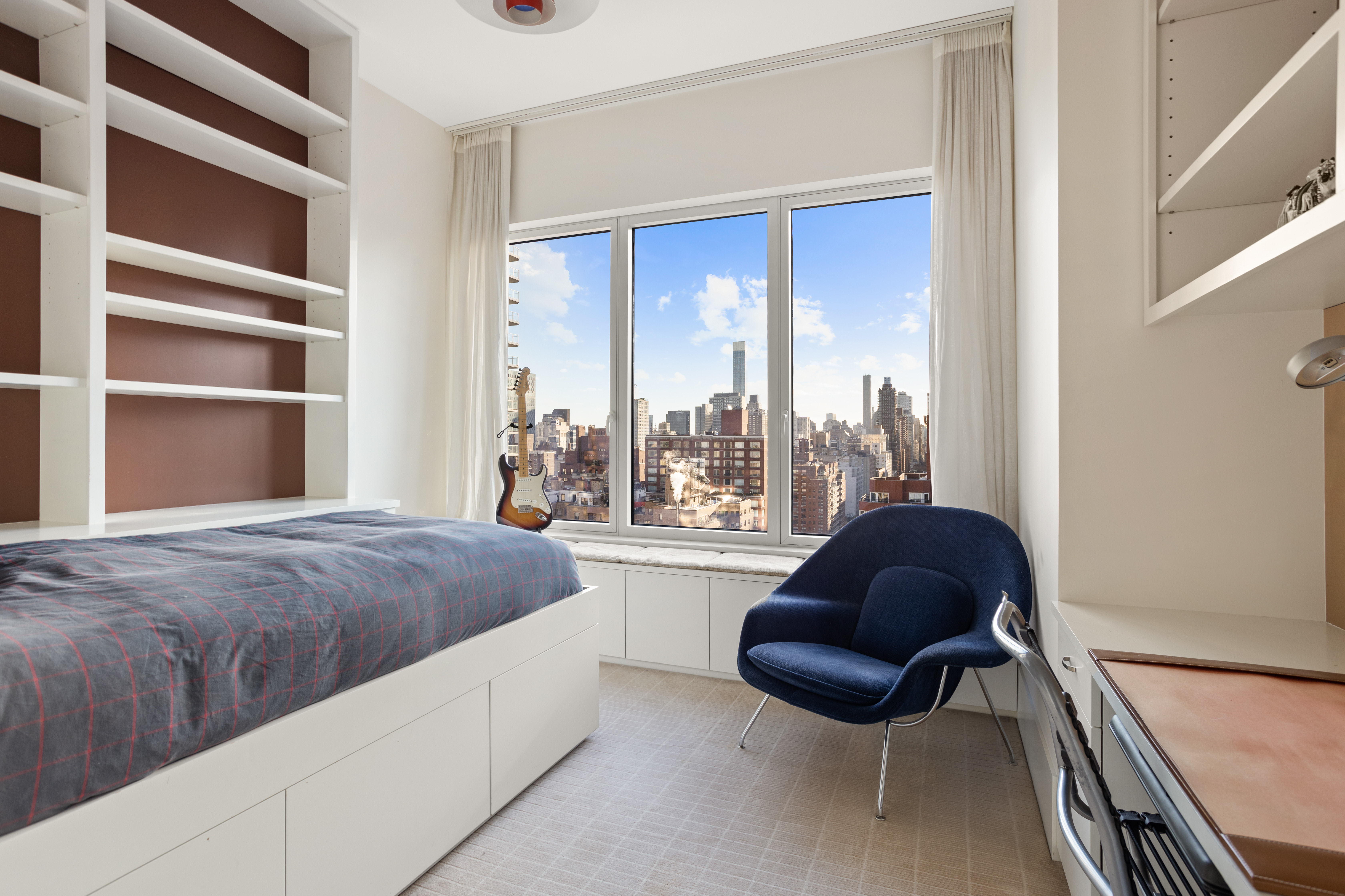 255 East 74th Street, Unit 21AB Manhattan, NY 10021 - Photo 19 of 37 a living room with furniture and a large window