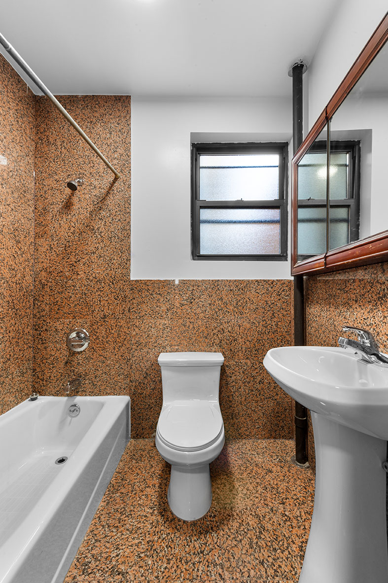 117 Mulberry Street, Unit 14 Manhattan, NY 10013 - Photo 4 of 4 a bathroom with a toilet sink and mirror