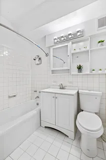 a bathroom with a sink a toilet and bathtub