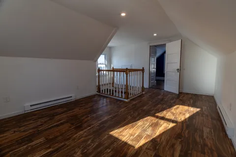 a view of staircase with railing and white walls