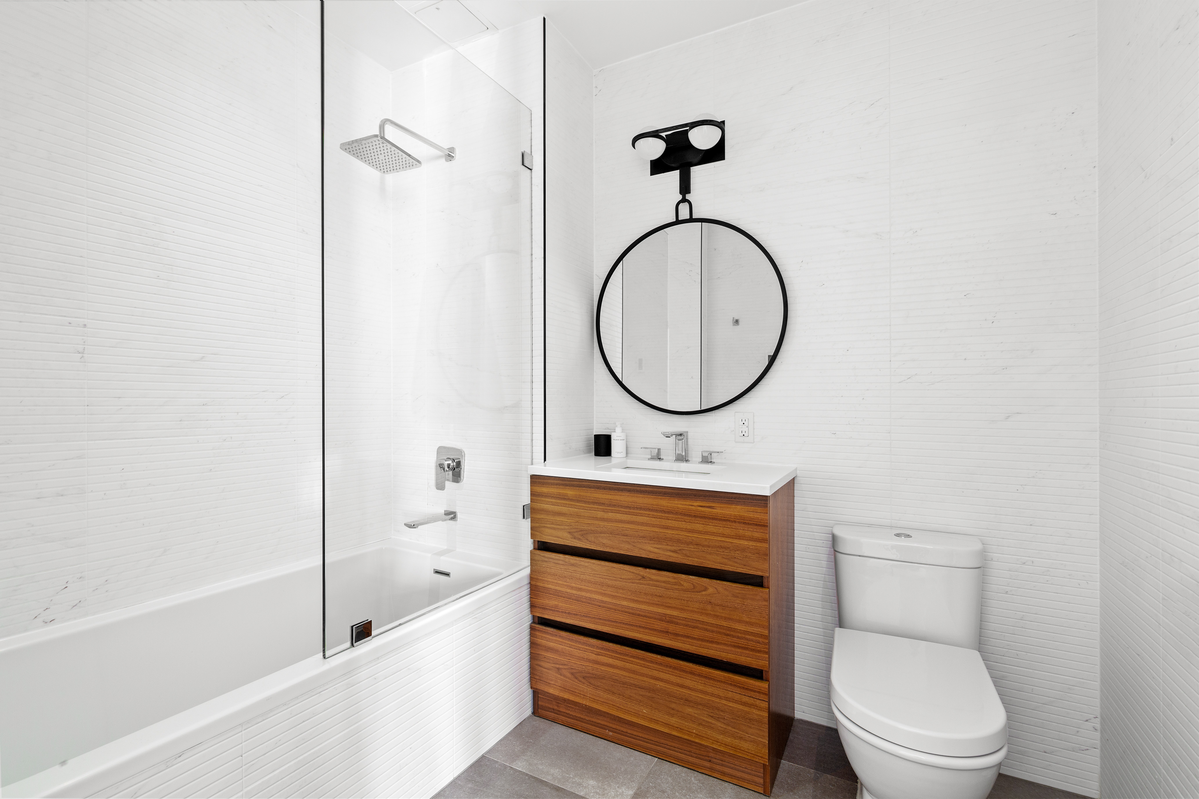 112 Fleet Place, Unit 12A Brooklyn, NY 11201 - Photo 8 of 15 a bathroom with a toilet sink vanity tub and shower