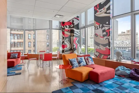 a living room filled with furniture and a floor to ceiling window