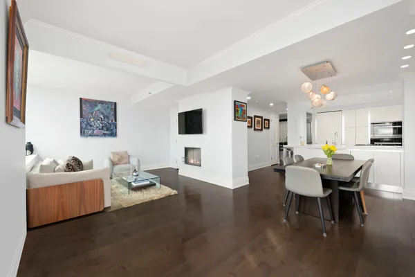 a living room with furniture and a dining table with kitchen view