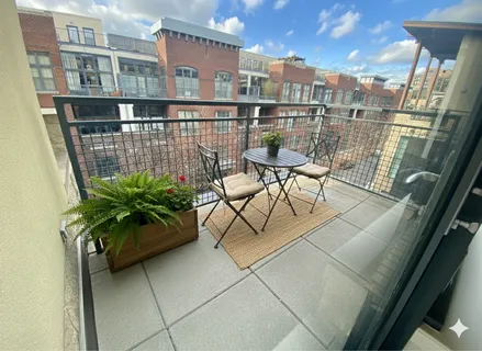 a balcony with table and chairs
