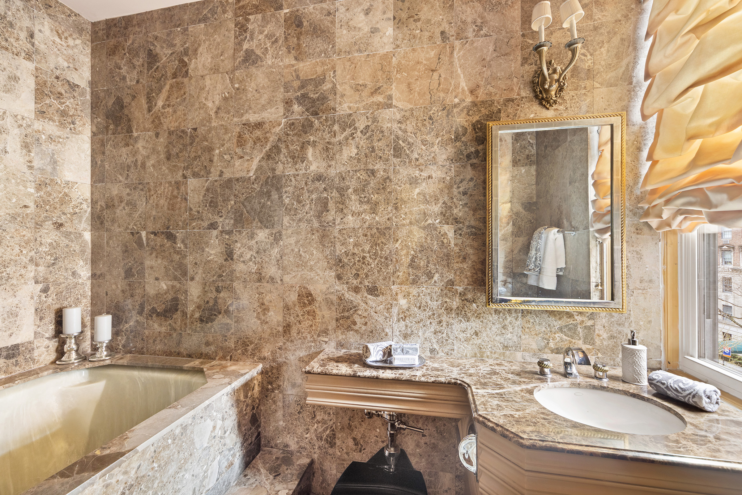 31 East 72nd Street, Unit 4B Manhattan, NY 10021 - Photo 9 of 14 a bathroom with a granite countertop sink and a bathtub
