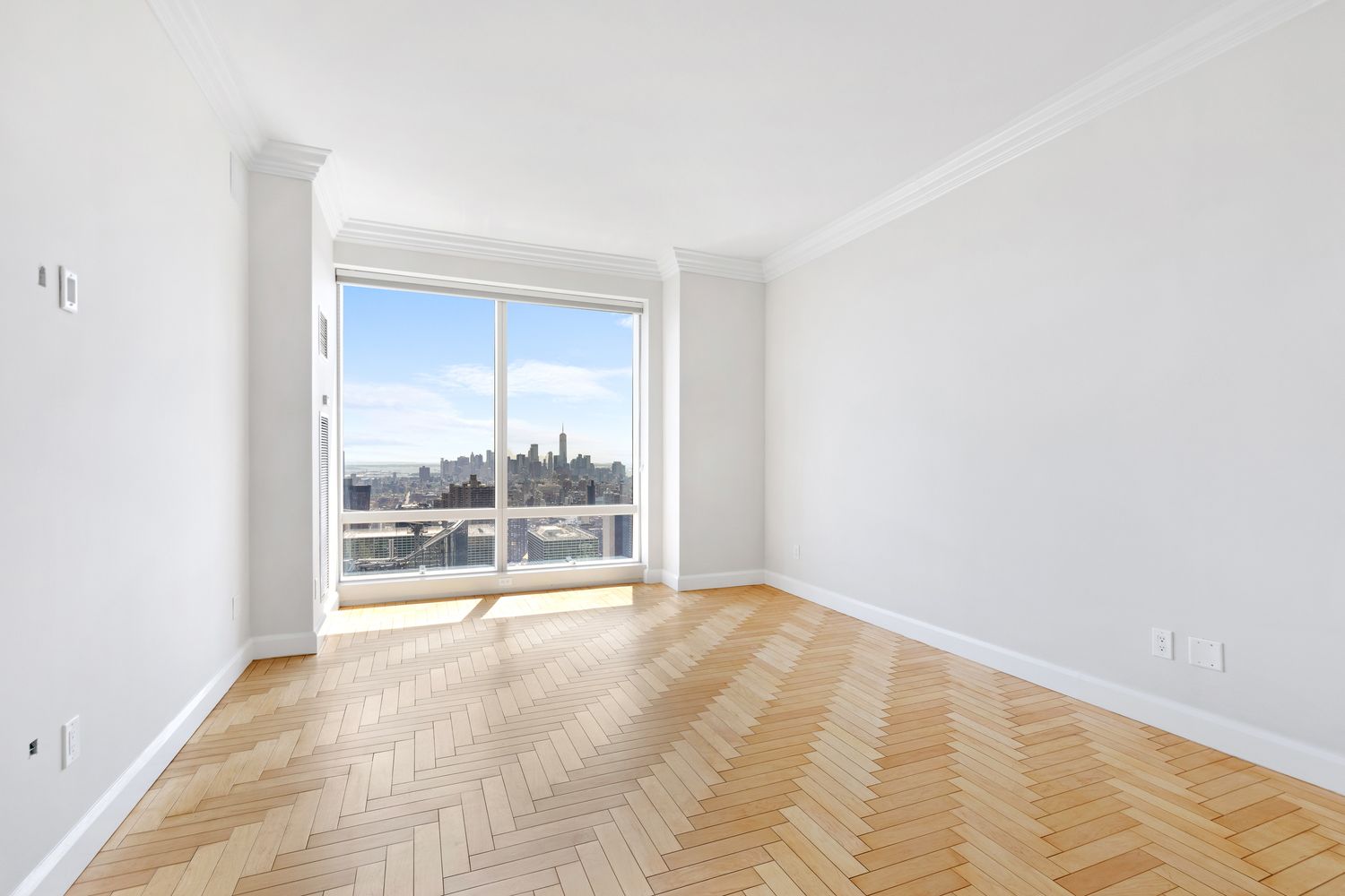 845 United Nations Plaza, Unit 63B Manhattan, NY 10017 - Photo 11 of 14 an empty room with wooden floor and windows