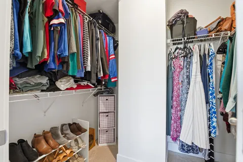 a view of walk in closet with clothes