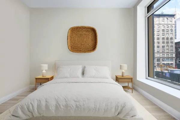 a bedroom with a bed and a large window