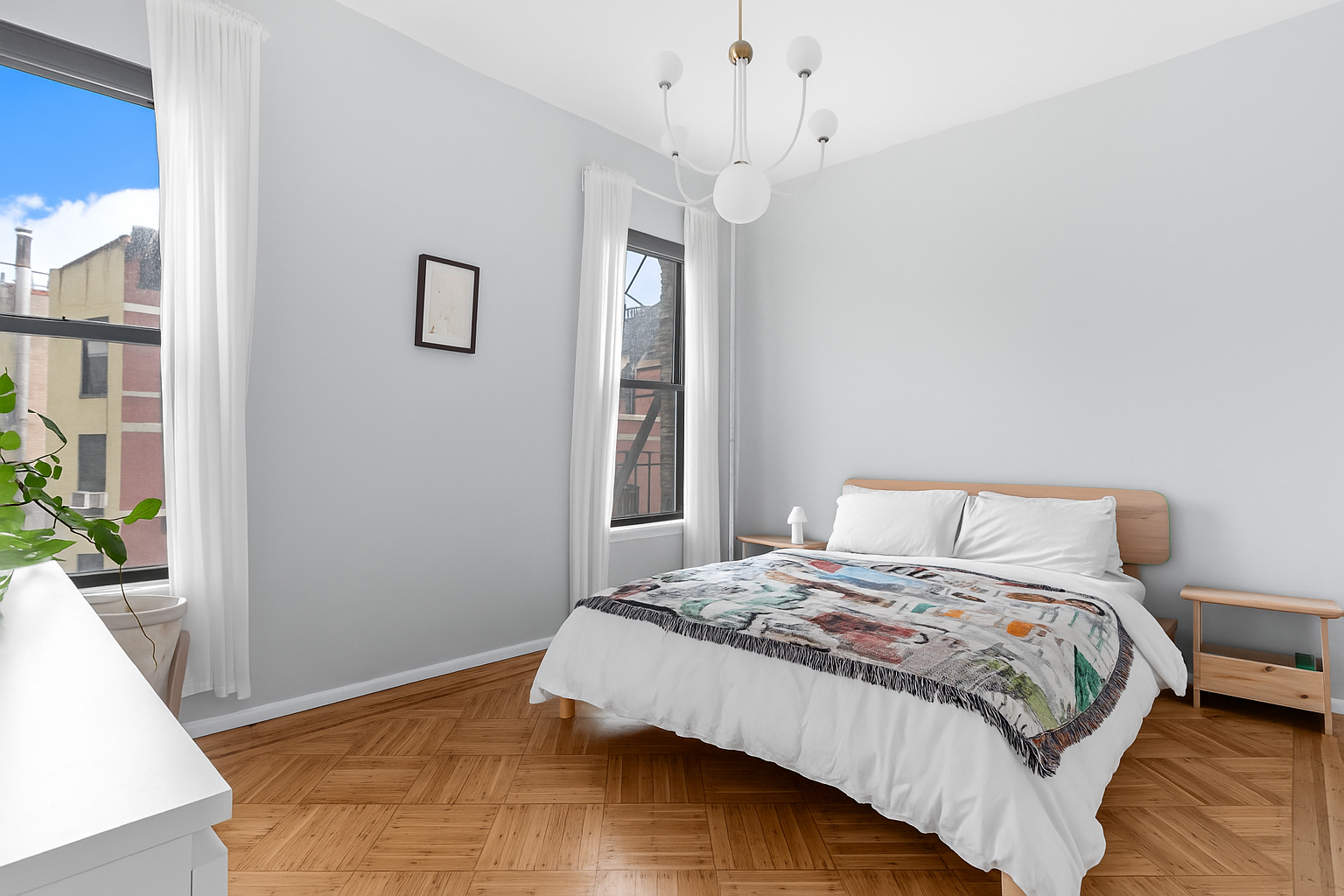 394 Lincoln Place, Unit C2 Brooklyn, NY 11238 - Photo 8 of 13 a bedroom with a large bed and a chandelier