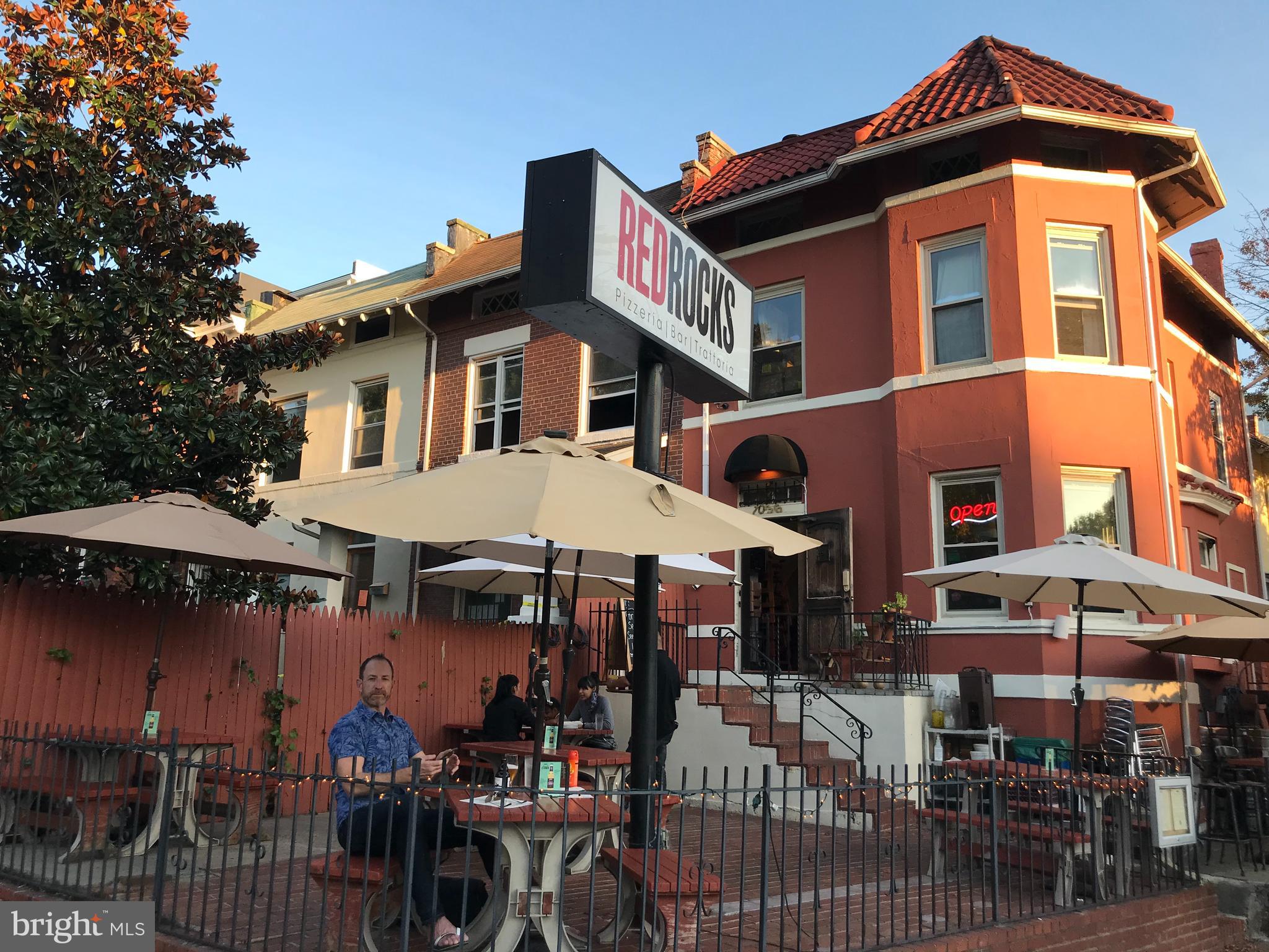1033 Park Road Northwest, Unit 6 Washington, DC 20010 - Photo 25 of 38 a front view of a building with outdoor seating