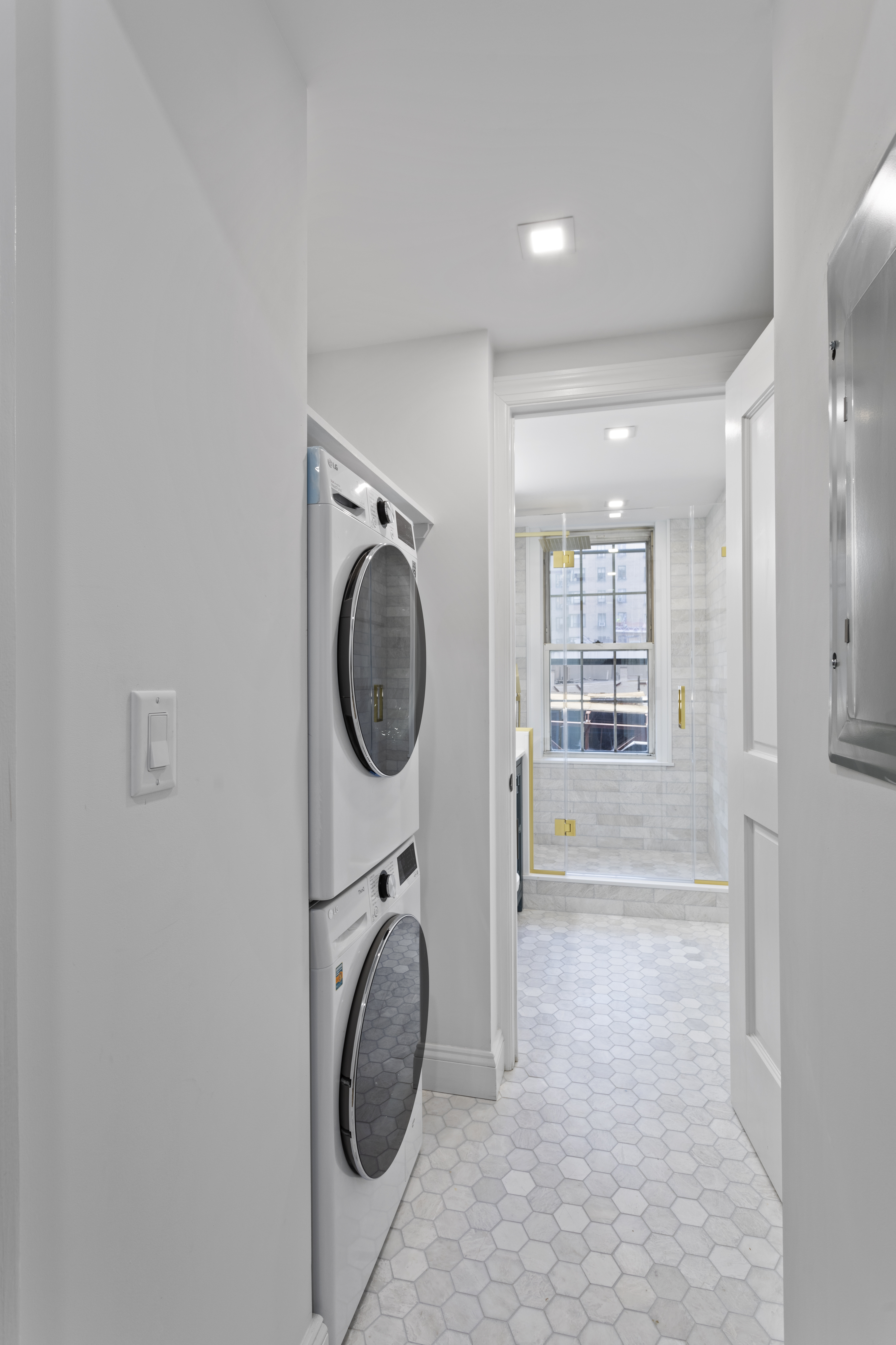 16 Park Avenue, Unit 6CD Manhattan, NY 10016 - Photo 4 of 12 a view of a storage & utility room with a washer dryer