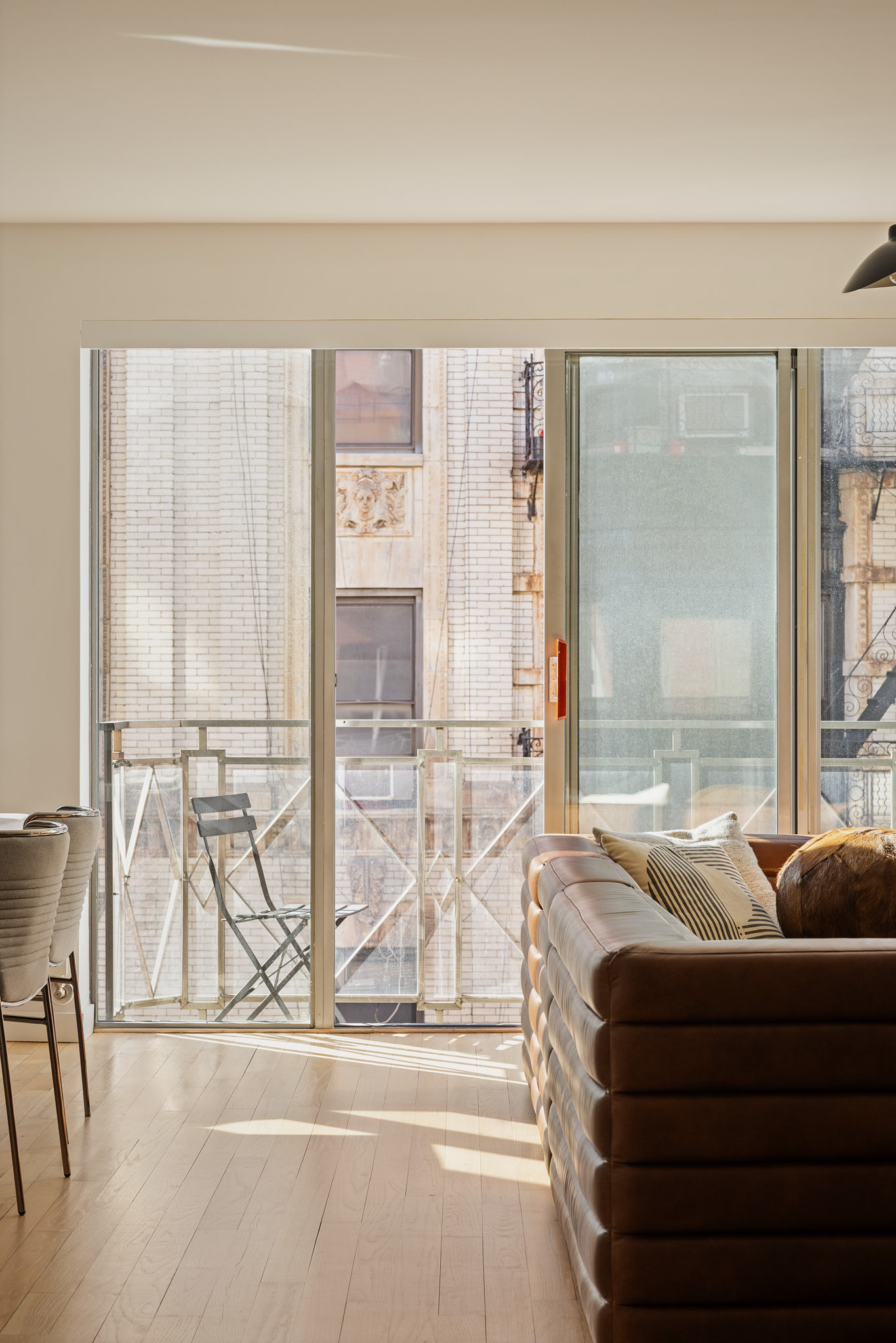 182 Mulberry Street, Unit 4 Manhattan, NY 10012 - Photo 4 of 13 a living room with furniture and a large window