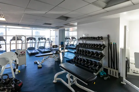 a room with gym equipment and a large window