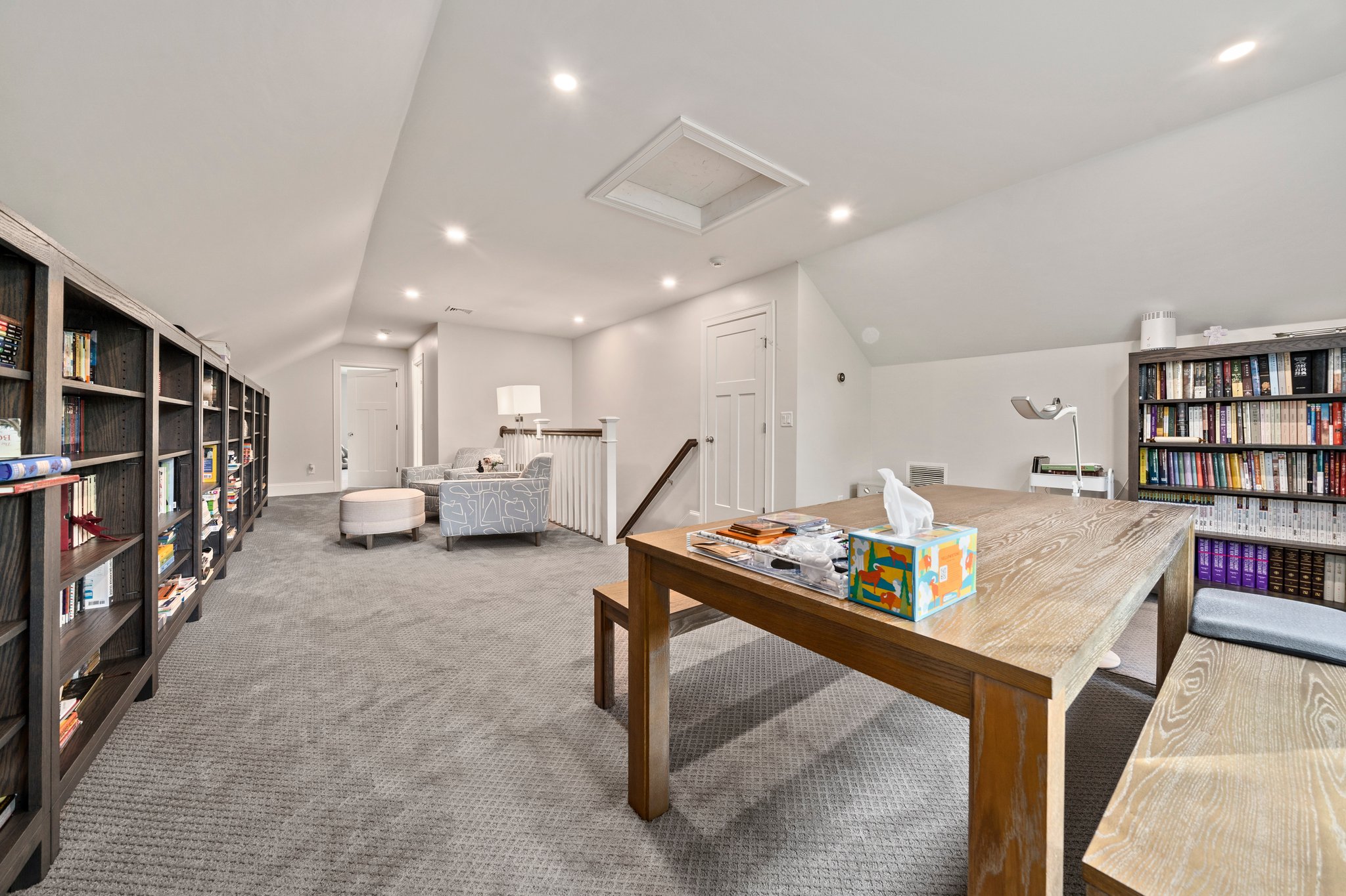 241 Lowell Road Wellesley, MA 02481 - Photo 49 of 85 a living room with lots of furniture and a book shelf