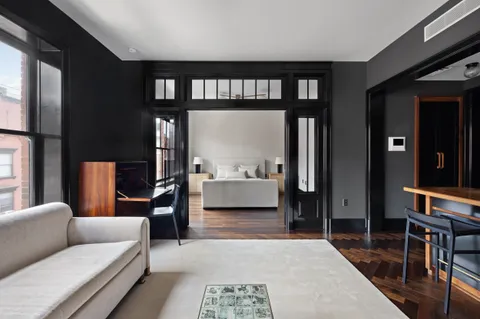 a living room with furniture a rug and a large window