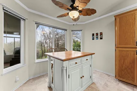 a kitchen with a stove a sink a window and a refrigerator