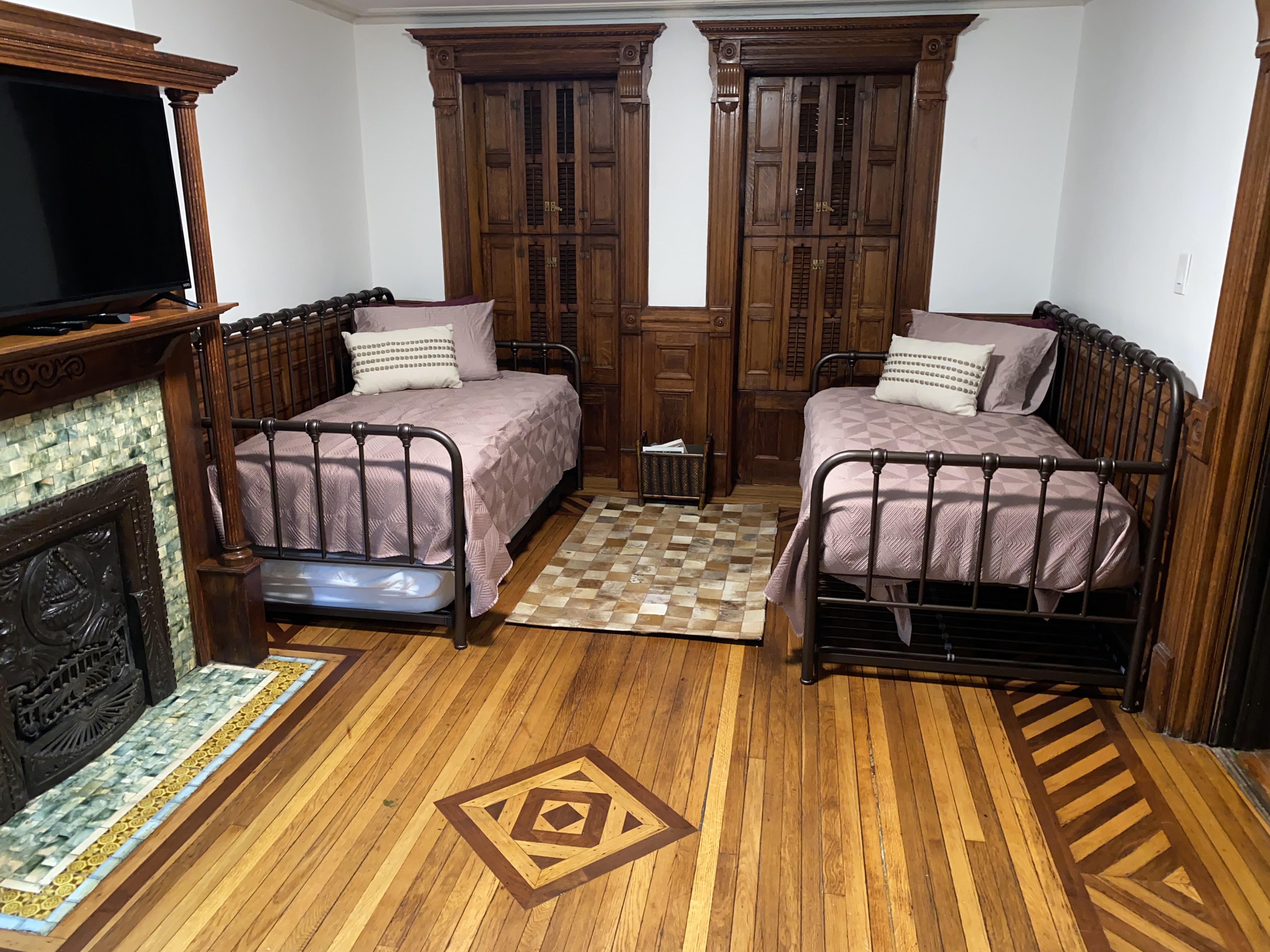 493 Decatur Street, Unit 1 Brooklyn, NY 11233 - Photo 2 of 26 a bedroom with a bed and wooden floor