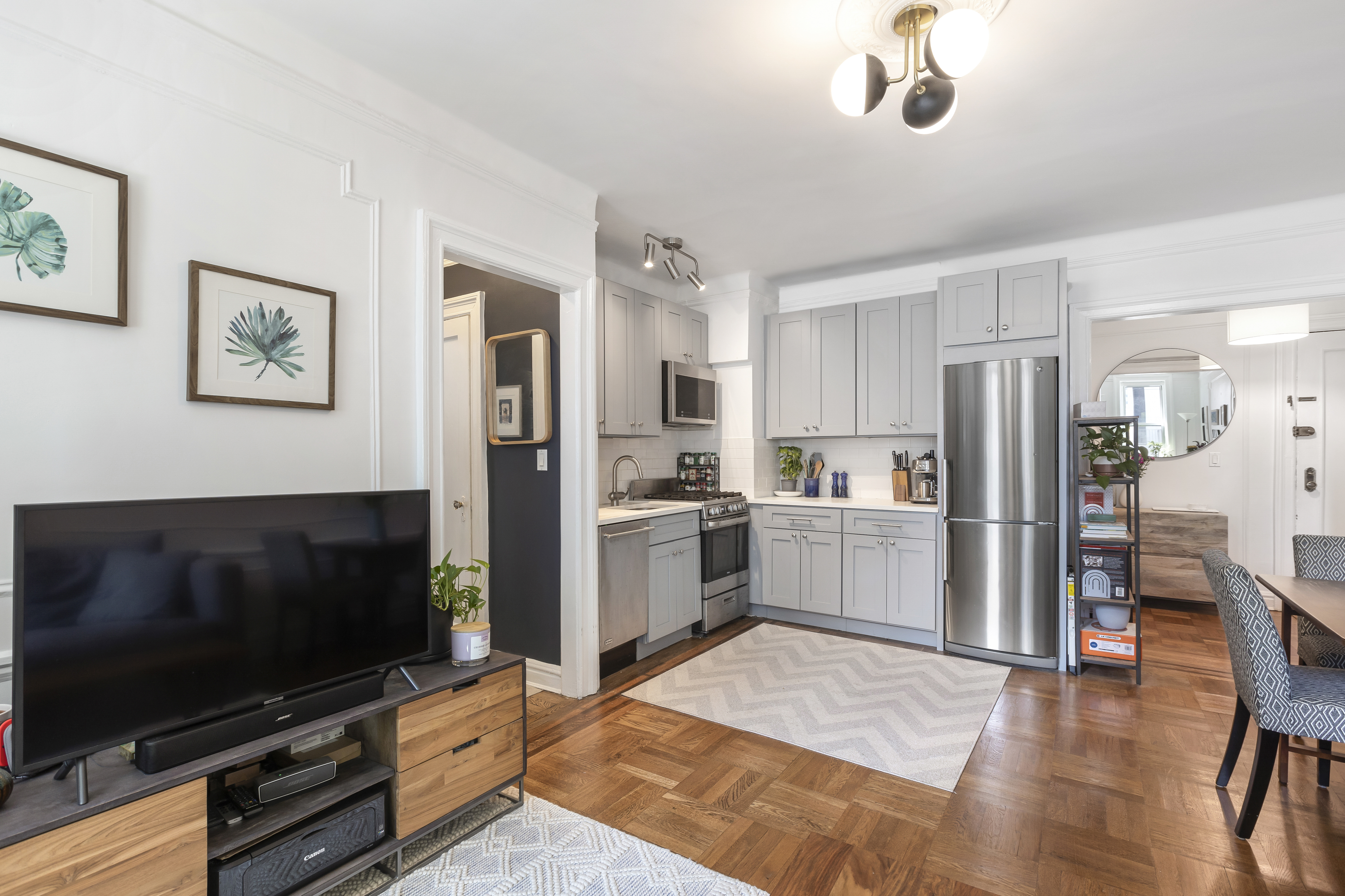 30 Clinton Street, Unit 6A Brooklyn, NY 11201 - Photo 6 of 11 a kitchen with stainless steel appliances wooden floor and a refrigerator