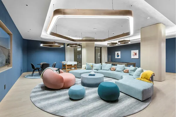 a living room with furniture and a chandelier